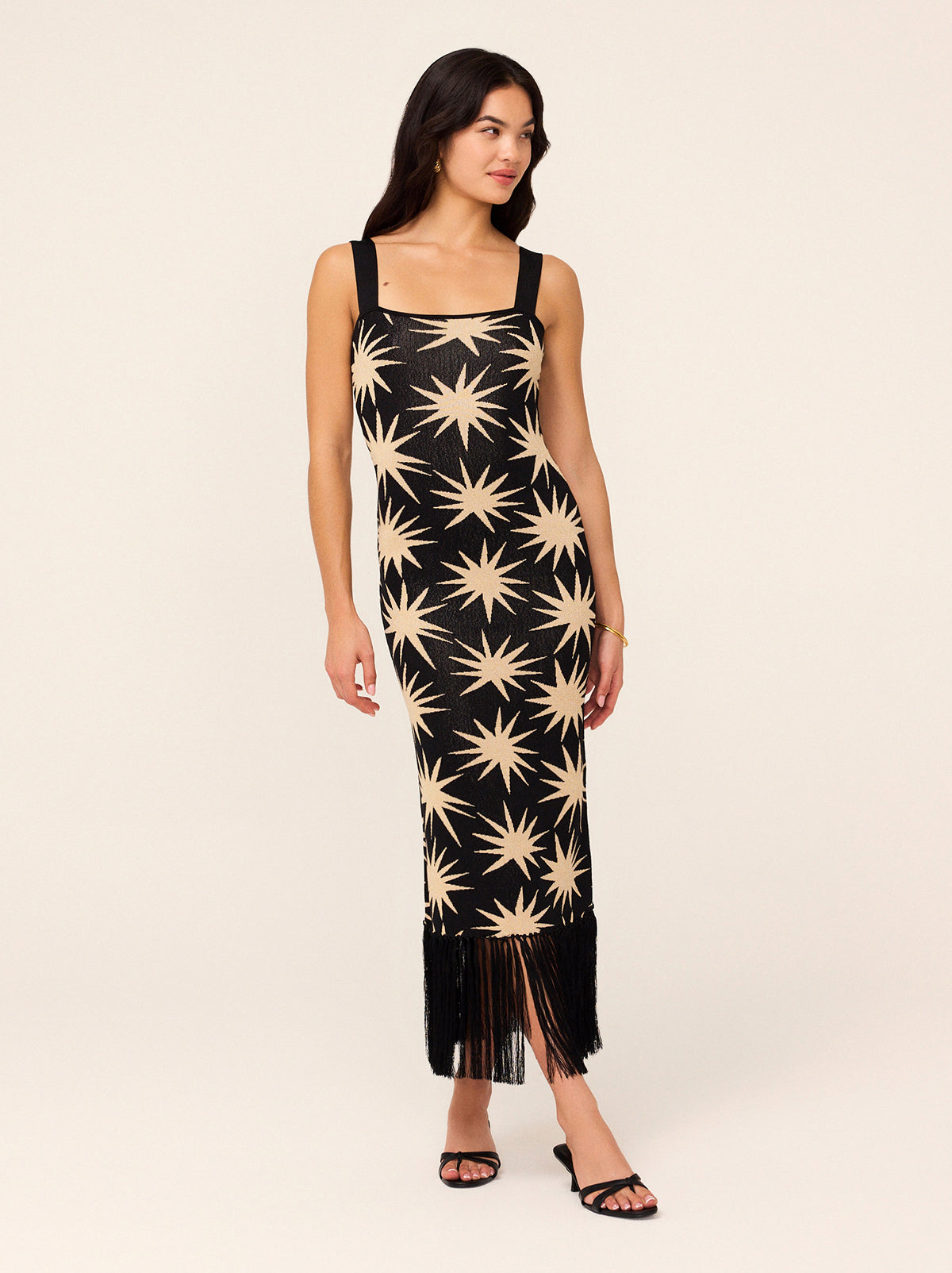 Talitha Black Star Lurex Knit Dress - Talitha is a flattering and figure-hugging lurex knit, her wide straps are bra-friendly and her hem fringing adds some drama. Not to mention the golden stars woven through for added shimmer. 