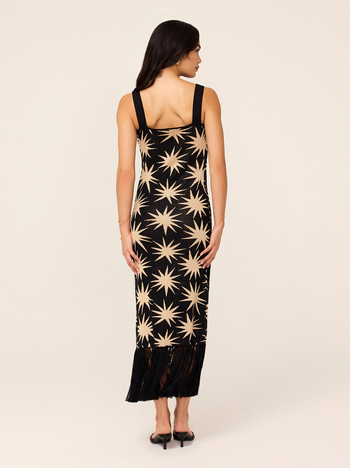 Talitha Black Star Lurex Knit Dress - Talitha is a flattering and figure-hugging lurex knit, her wide straps are bra-friendly and her hem fringing adds some drama. Not to mention the golden stars woven through for added shimmer. 