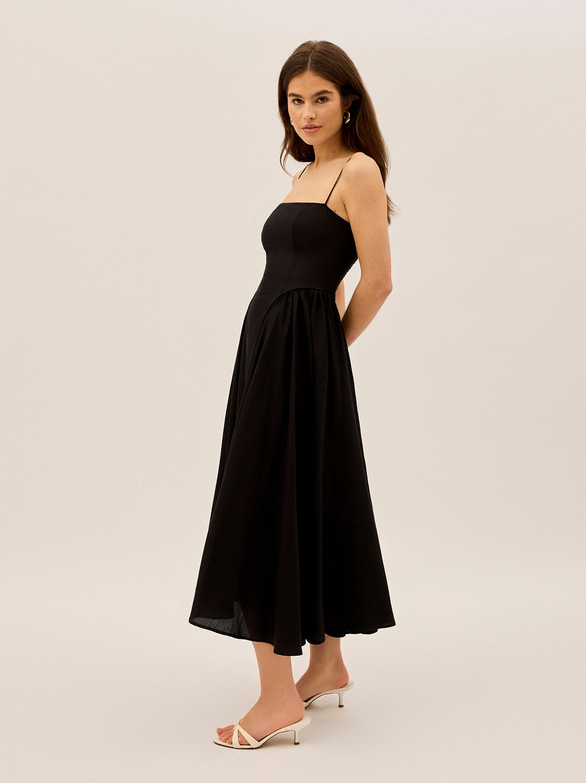 Alberta Black Linen Blend Dress by Kitri Studio. Alberta is an effortlessly elegant maxi dress designed to turn heads.  Crafted from a breathable linen blend with a touch of Tencel for a soft, fluid drape, this dress blends structure with movement. Straight neckline. Spaghetti straps. Centre-back zip closure. Shell: 80%% Lenzing Tencel™ Lyocell 20%% Linen Lining: 100%% Recycle Polyester.