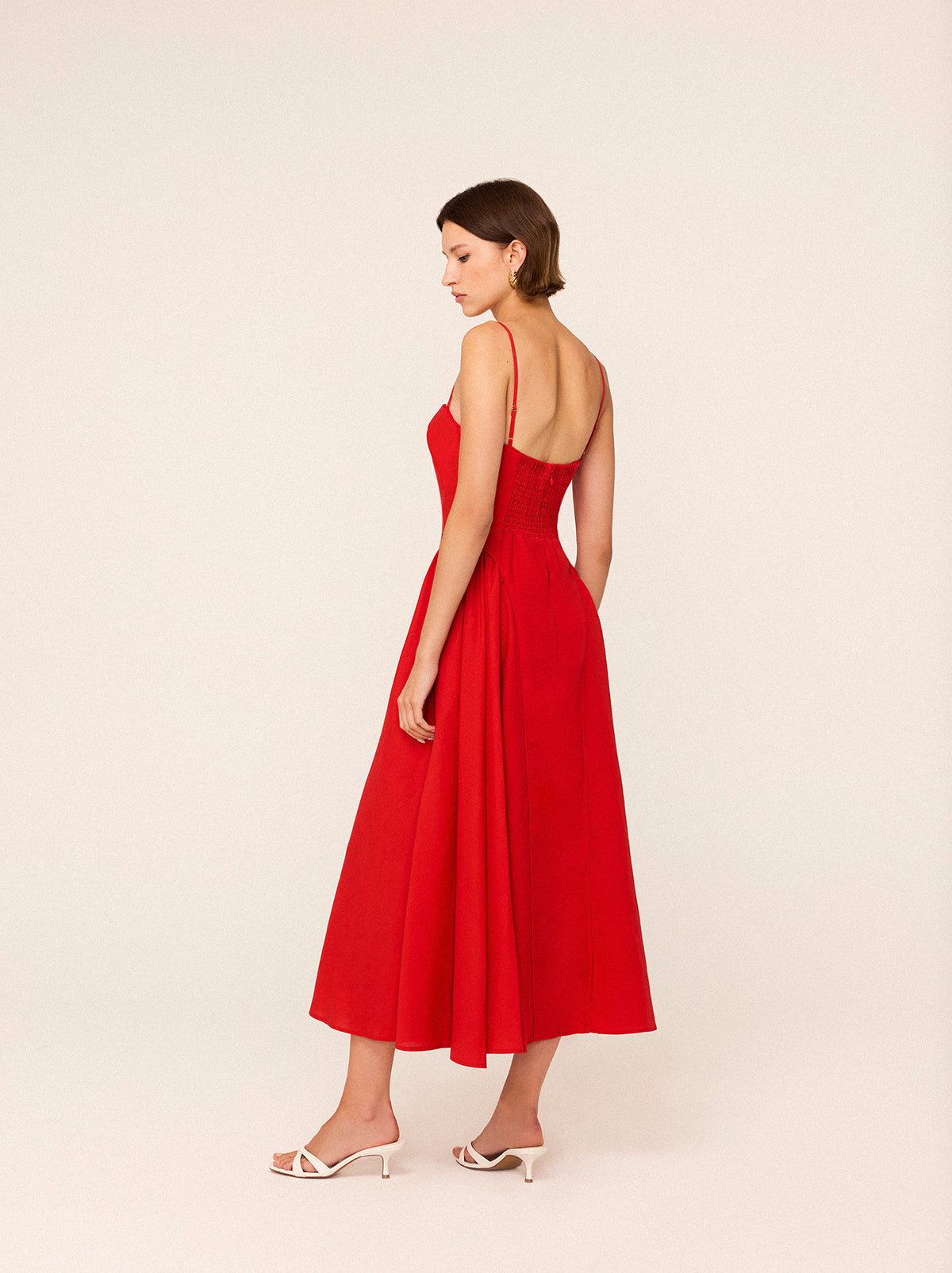 Alberta Red Linen Blend Dress by Kitri Studio. Alberta is an effortlessly elegant maxi dress designed to turn heads.  Crafted from a breathable Tencel blend with a touch of hemp for a soft, fluid drape, this dress blends structure with movement. Straight neckline. Spaghetti straps. Centre-back zip closure. Shell:Lenzing TM 70%% Tencel 30%% Linen Lining: 100%% Recycled Polyester.