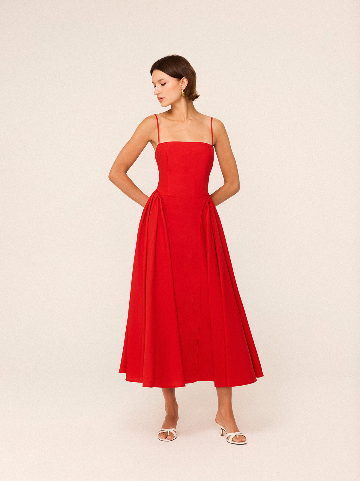 Alberta Red Linen Blend Dress by Kitri Studio. Alberta is an effortlessly elegant maxi dress designed to turn heads.  Crafted from a breathable Tencel blend with a touch of hemp for a soft, fluid drape, this dress blends structure with movement. Straight neckline. Spaghetti straps. Centre-back zip closure. Shell:Lenzing TM 70%% Tencel 30%% Linen Lining: 100%% Recycled Polyester.