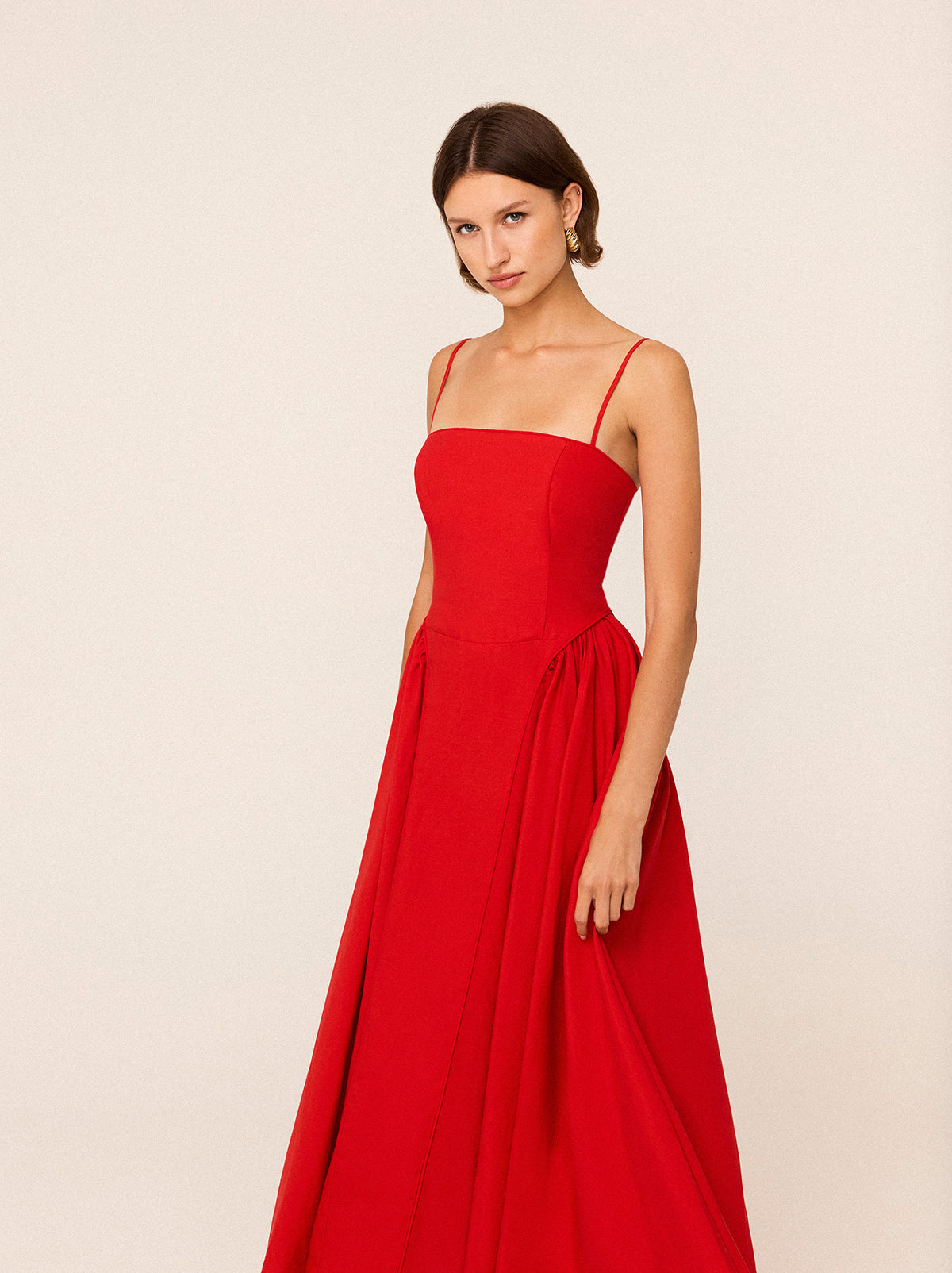 Alberta Red Linen Blend Dress by Kitri Studio. Alberta is an effortlessly elegant maxi dress designed to turn heads.  Crafted from a breathable Tencel blend with a touch of hemp for a soft, fluid drape, this dress blends structure with movement. Straight neckline. Spaghetti straps. Centre-back zip closure. Shell:Lenzing TM 70%% Tencel 30%% Linen Lining: 100%% Recycled Polyester.