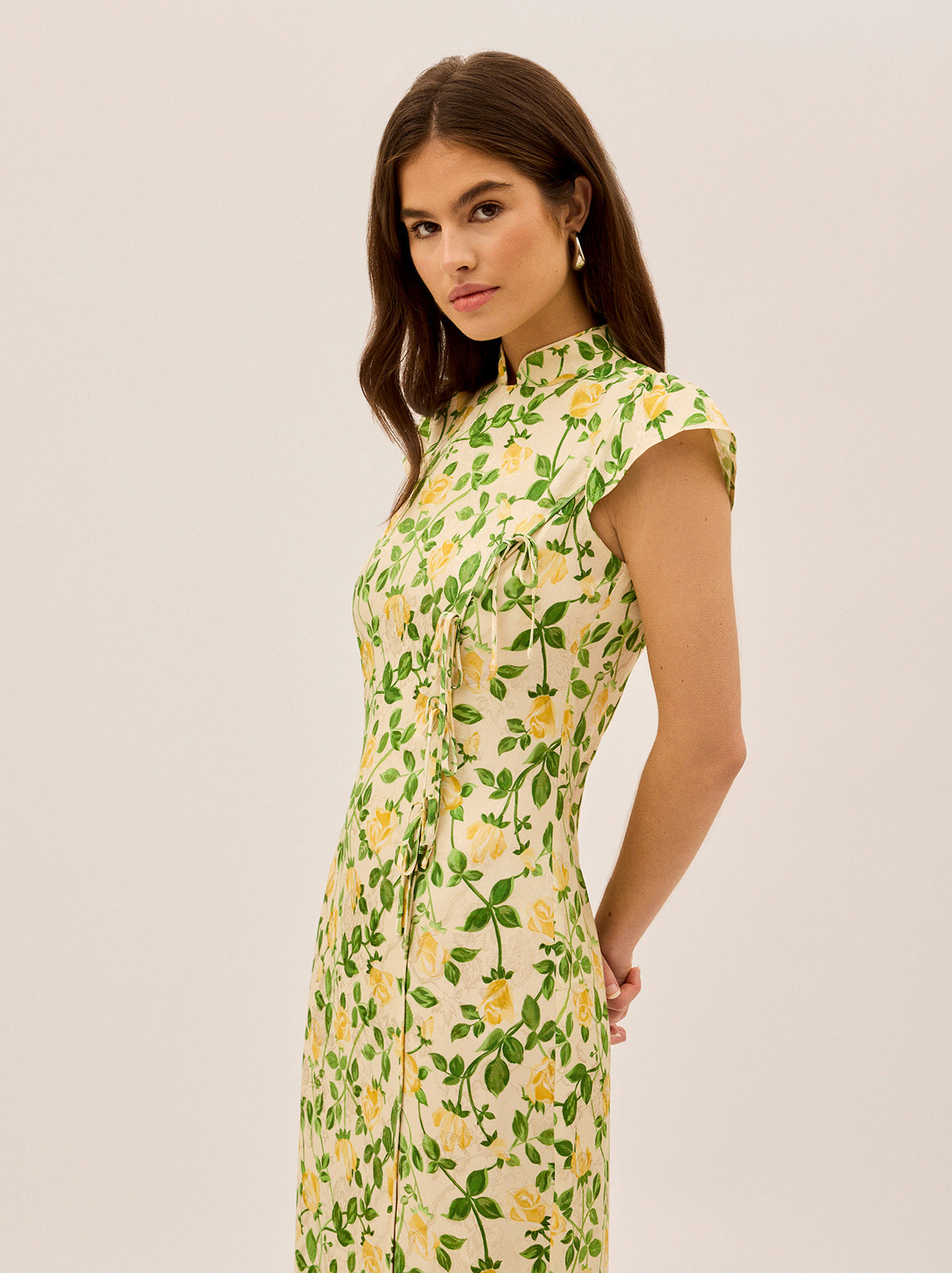 Elena Yellow Rose Printed Jacquard Dress by Kitri Studio. Meet Elena, your new favourite dress for when you want to make an effortlessly chic statement.  A modern take on the classic cheongsam silhouette, this midi dress is crafted from printed viscose jacquard with delicate tie details down the front panel and a playful split over one leg—because a little drama never hurt anyone. . . . .