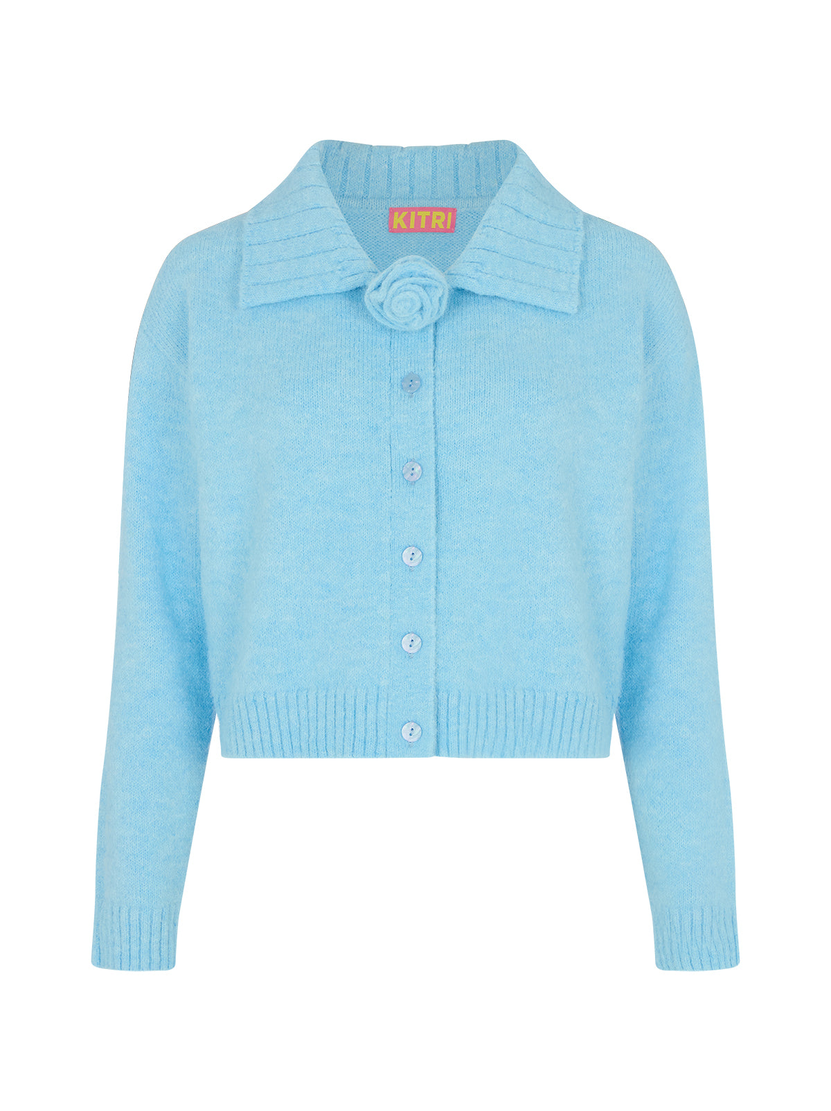 Abigail Blue Knit Cardigan by Kitri Studio. Abigail is a soft powder blue alpaca-wool cardigan with a feminine collared design, finished with a removable rose corsage at the neck.  The buttery soft hand-feel and timeless charm of this cardigan make it a go-to piece you'll reach for again and again. Collared neckline. Long sleeves. Ribbed cuffs. 59% Recycled Polyester, 21% Nylon, 11% Polyester, 8% Wool, 1% Elastane.