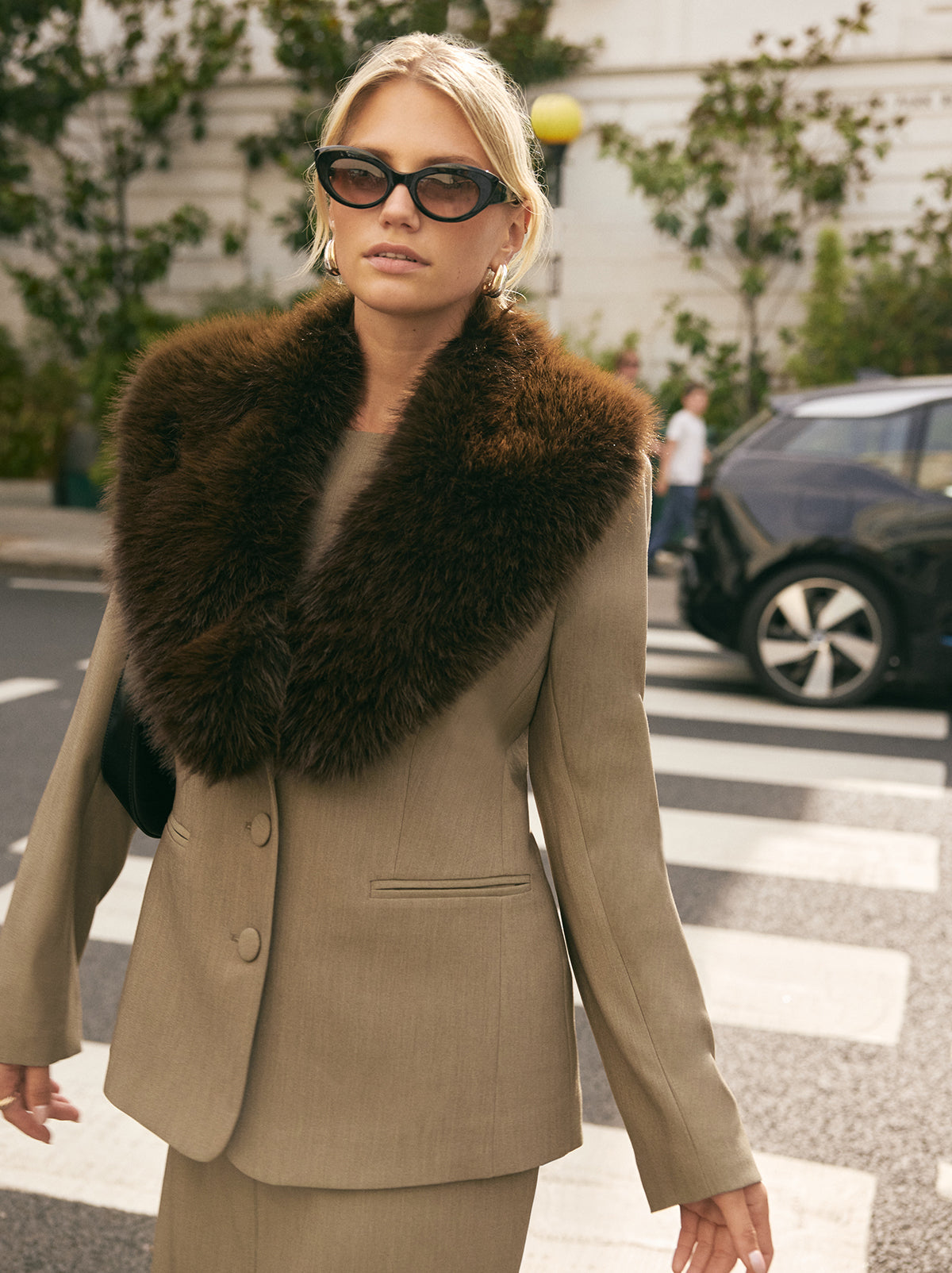 Anthia Tailored Blazer by Kitri Studio. The Anthia blazer brings statement-making polish to your wardrobe.  Expertly tailored in a versatile taupe hue, it’s cinched at the waist for a flattering fit and finished with a detachable faux-fur collar in rich chocolate brown for a touch of vintage glamour. Long sleeves. Button front. Fully lined. Main: 74% Polyester, 20% Rayon, 6% Elastane Faux Fur: 100% Polyester.