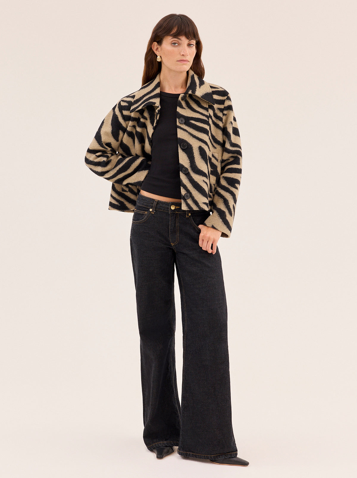 Bonnie Zebra Wool-Blend Jacket by Kitri Studio. Bestselling Bonnie returns in a bold zebra update, cut from a soft wool-blend for all-day comfort with a luxe finish.  Designed with a boxy silhouette, it’s detailed with detachable dark chocolate faux-fur trims at the collar and cuffs for a touch of drama. Collared neckline. Long sleeves. Button front. Main: 30% Wool, 70% Polyester Faux Fur: 100% Polyester.