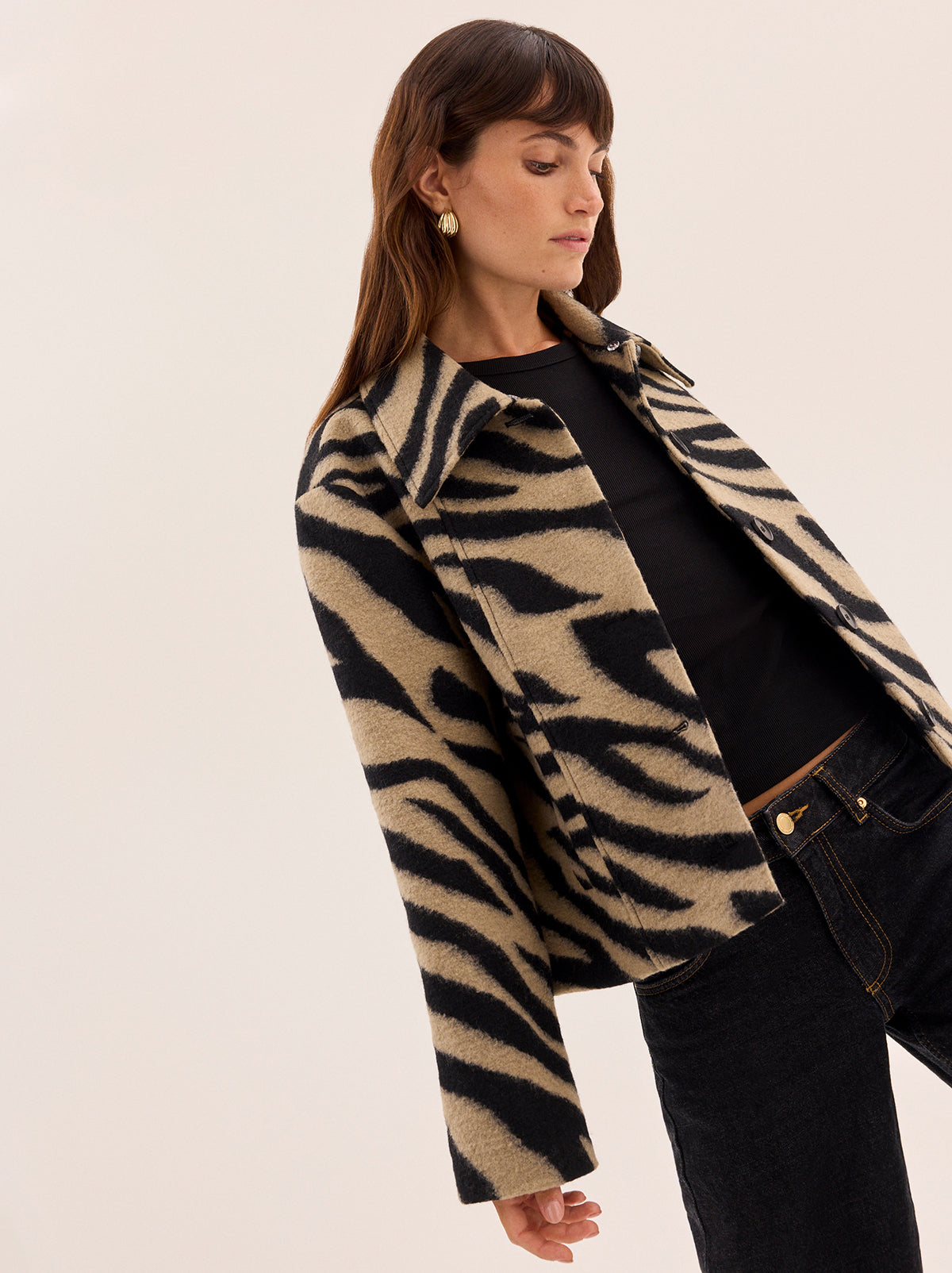 Bonnie Zebra Wool-Blend Jacket by Kitri Studio. Bestselling Bonnie returns in a bold zebra update, cut from a soft wool-blend for all-day comfort with a luxe finish.  Designed with a boxy silhouette, it’s detailed with detachable dark chocolate faux-fur trims at the collar and cuffs for a touch of drama. Collared neckline. Long sleeves. Button front. Main: 30% Wool, 70% Polyester Faux Fur: 100% Polyester.