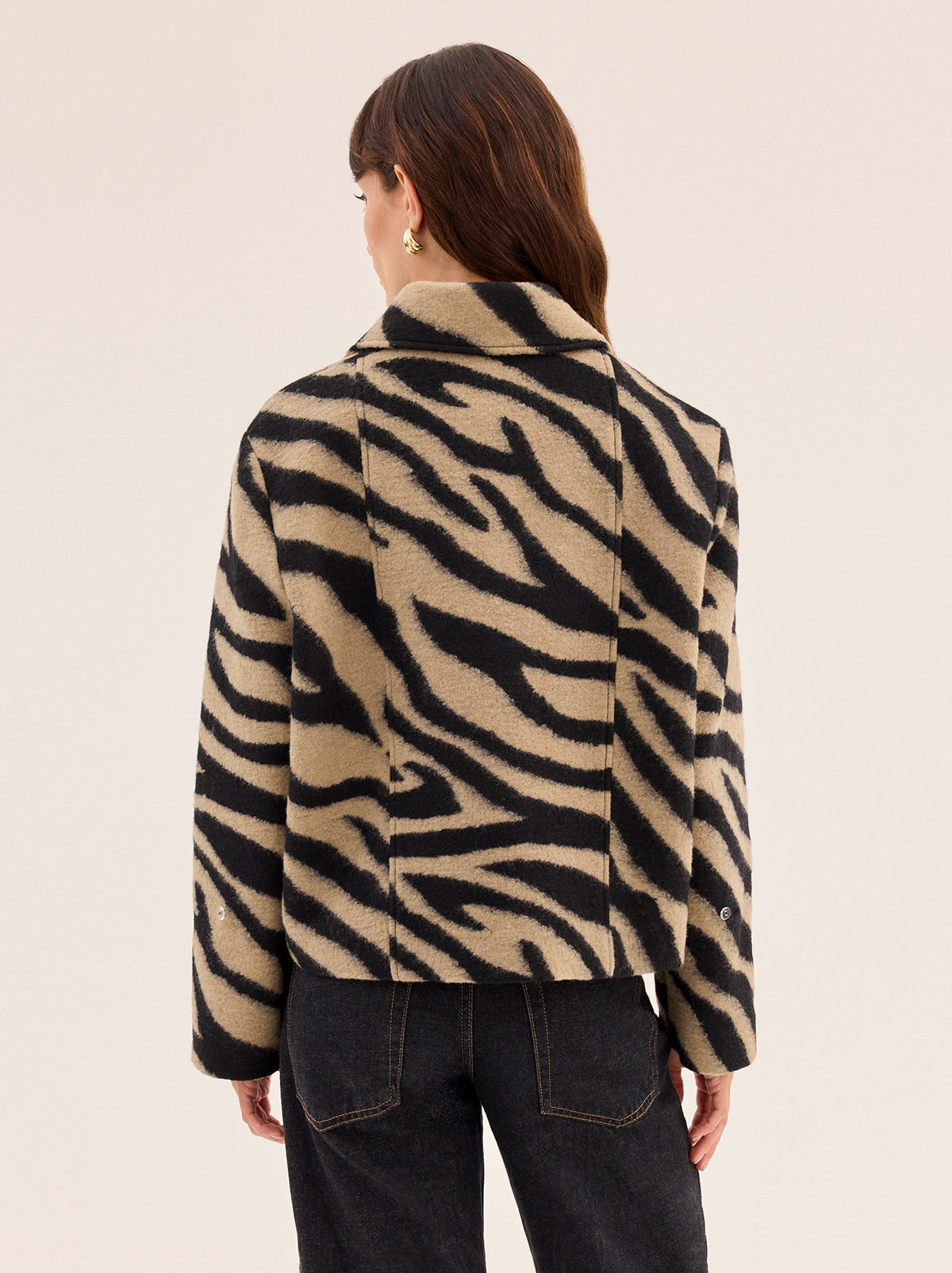 Bonnie Zebra Wool-Blend Jacket by Kitri Studio. Bestselling Bonnie returns in a bold zebra update, cut from a soft wool-blend for all-day comfort with a luxe finish.  Designed with a boxy silhouette, it’s detailed with detachable dark chocolate faux-fur trims at the collar and cuffs for a touch of drama. Collared neckline. Long sleeves. Button front. Main: 30% Wool, 70% Polyester Faux Fur: 100% Polyester.