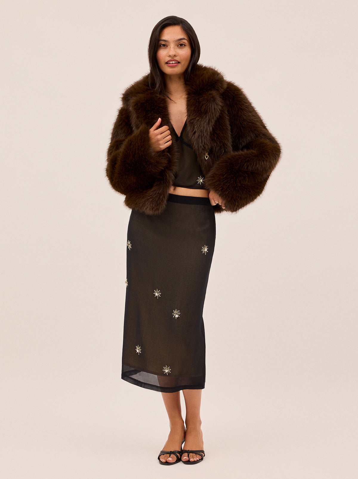 Noor Dark Chocolate Faux Fur Jacket by Kitri Studio. Wrap yourself in warmth and style with the Noor Dark Chocolate Faux Fur Jacket.  Designed in an ultra-plush, deep chocolate hue, this statement piece features an exaggerated collar and long sleeves for a glamorous yet wearable look. Collared neckline. Long sleeves. Button front. 100% Polyester Faux Fur.