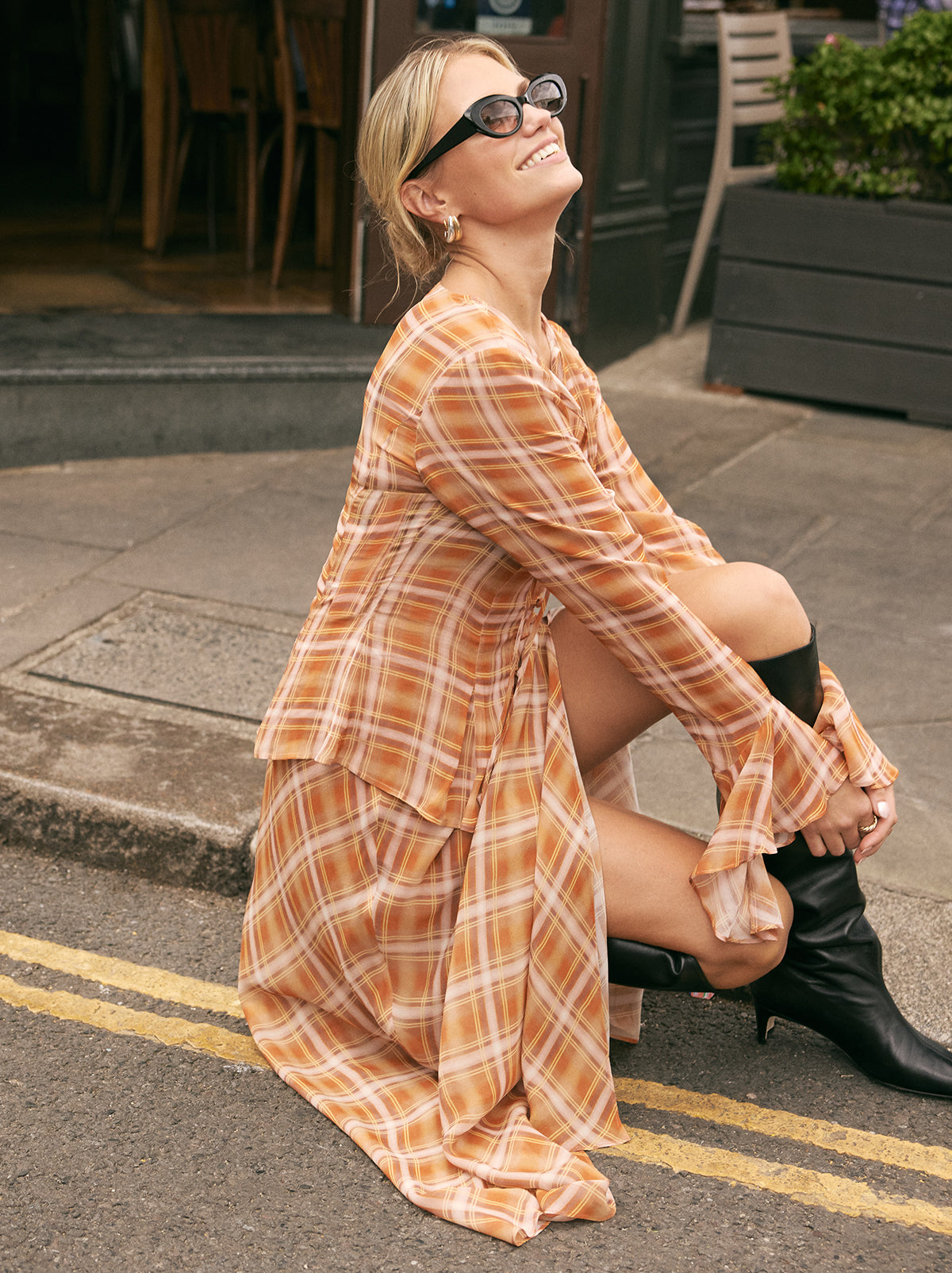 Zoe Apricot Check Print Skirt by Kitri Studio. The Zoe skirt is a flowing, feminine maxi crafted from semi-sheer viscose georgette in our exclusive apricot check print.  Designed with a mid-rise fit, it features a leg-baring split and is half lined for just the right amount of coverage. Half-lined. Elasticed waist. Flared skirt. 100% Viscose Georgette.