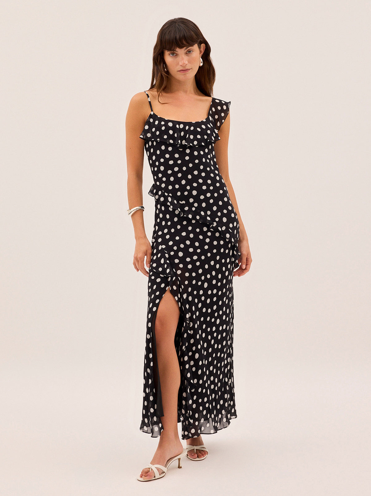 Delphina Black Polka Dot Dress by Kitri Studio. Meet the dress everyone will be asking about.  The Delphina Dress is a bold new silhouette in timeless polka dot print. One-shoulder. Spaghetti straps. Concealed side-zip. 100% Viscose Georgette.