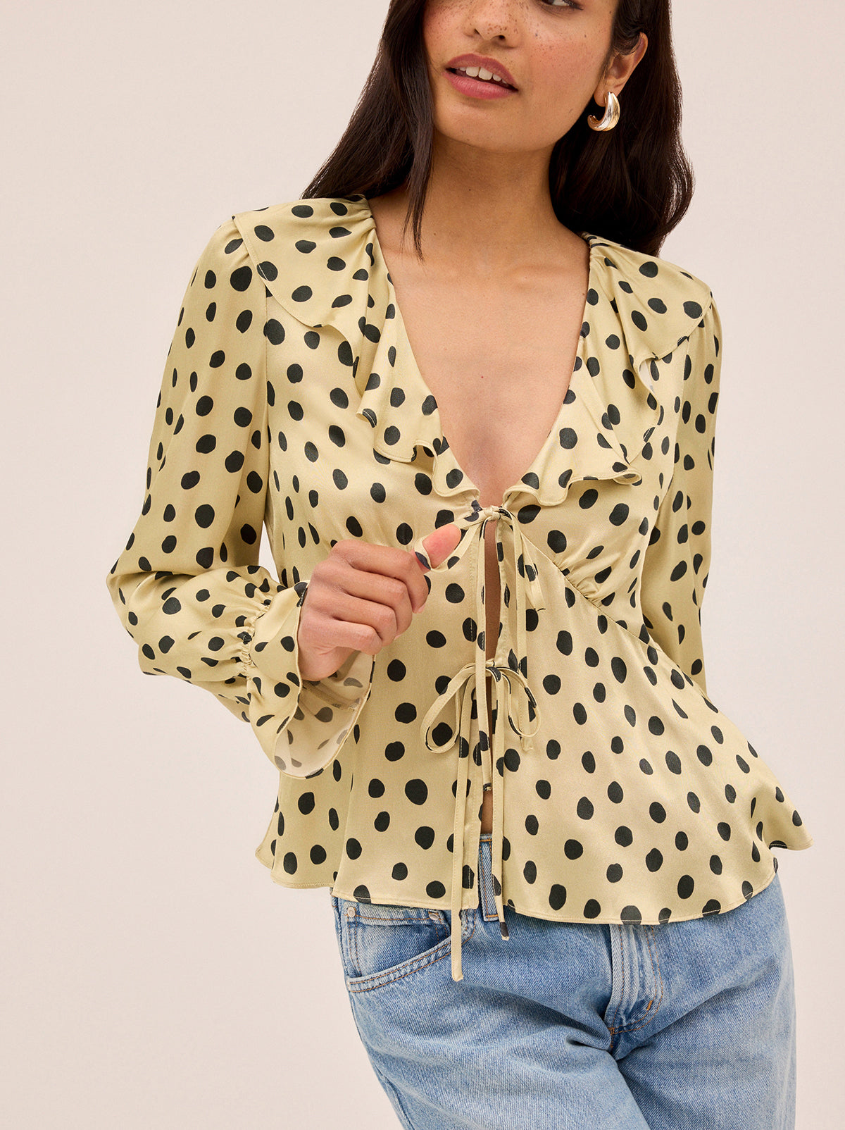 Ione Butter Polka Dot Satin Top by Kitri Studio. <span style="font-family: -apple-system, BlinkMacSystemFont, 'San Francisco', 'Segoe UI', Roboto, 'Helvetica Neue', sans-serif; font-size: 0. 875rem;">Romantic and effortless, the Ione top is new silhouette in soft, fluid viscose satin. V-neck. Long sleeves. Elasticated cuffs. 100% Viscose Satin.