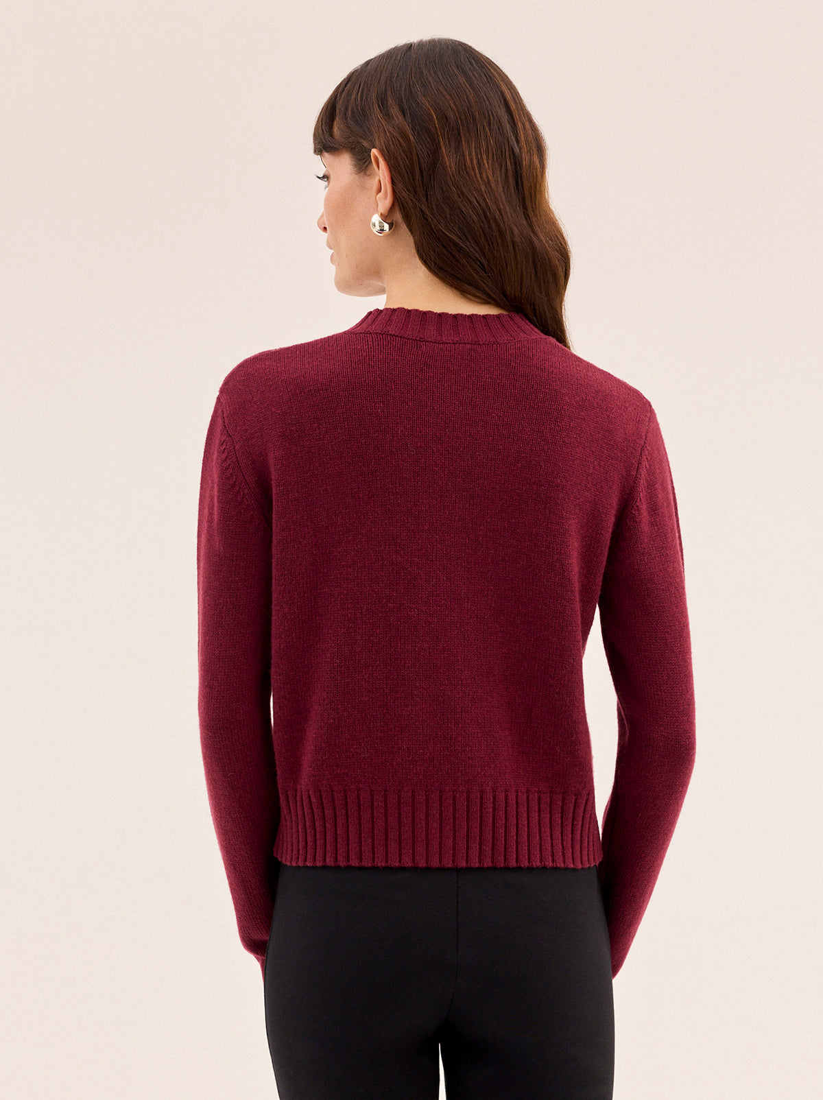 Isla Burgundy Hand-Embroidered Cardigan by Kitri Studio. A timeless layer with artisanal charm, this vintage-inspired cardigan is knitted from a soft wool and cashmere blend for a luxurious feel.  Designed in a rich burgundy hue, it features a classic round neckline, relaxed fit, and intricate hand-embroidered floral details across the front. Round neck. Long sleeves. Button front. 5% Cashmere, 20% Wool, 27% Viscose, 48% Nylon.