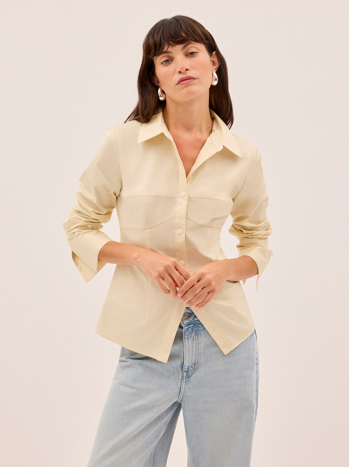 Jesse Vanilla Cotton Shirt by Kitri Studio. A refined take on a wardrobe classic.  The Jesse shirt debuts a new silhouette, cut from mid-weight 100% cotton in a soft vanilla hue. Collared neckline. Flared sleeves. Buttoned cuffs. 100% Cotton.