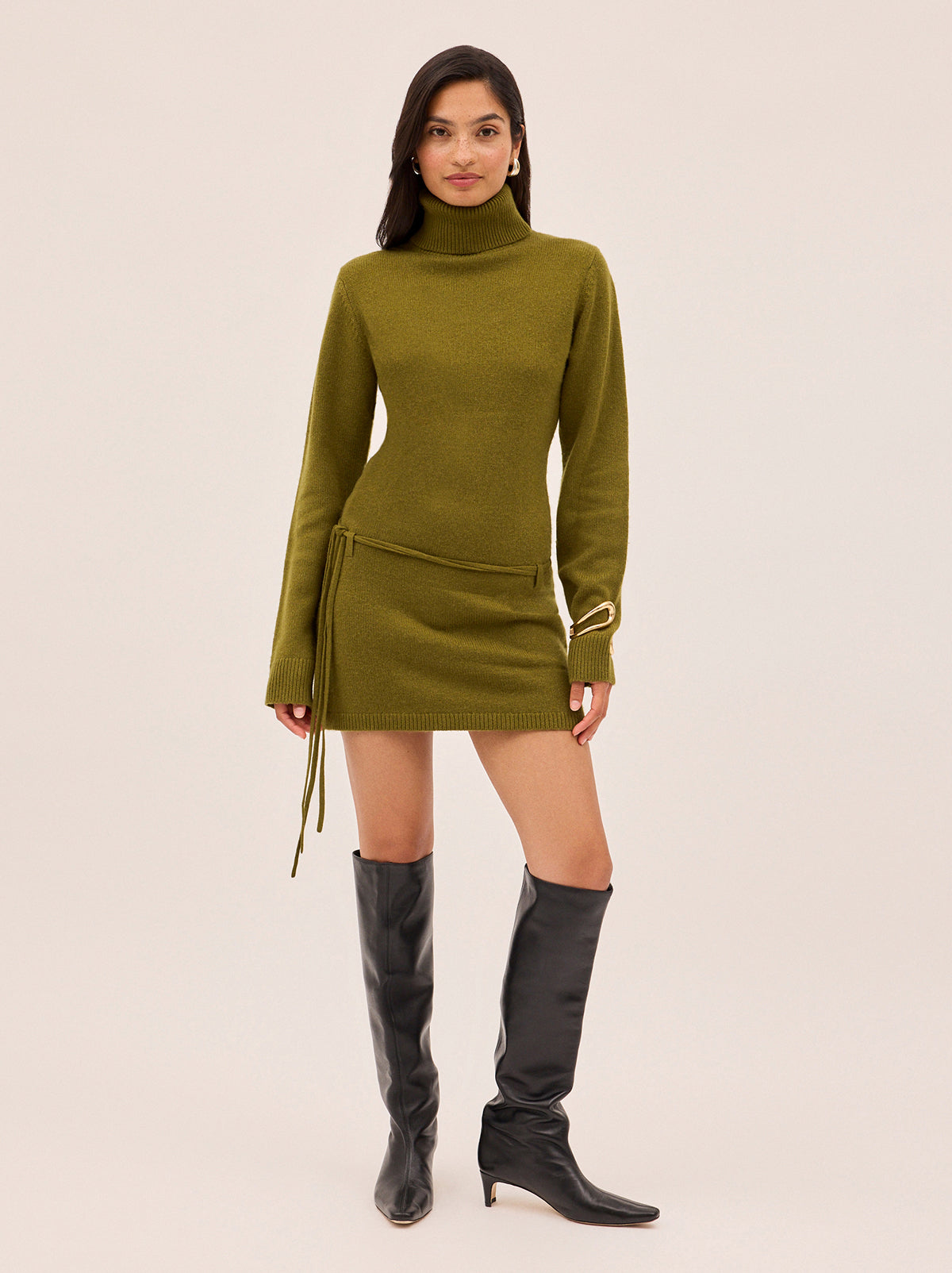 Juno Olive Wool-Blend Roll Neck Mini Dress by Kitri Studio. Make a statement in knitwear with our Juno Olive Wool-Blend Roll Neck Mini Dress.  Designed in a flattering slim fit, this vintage-inspired mini pairs a cosy roll neck with a softly structured silhouette for a look that’s as effortless as it is polished. High neckline. Long sleeves. Slim fit. 5% Cashmere, 20% Wool, 27% Viscose, 48% Nylon.