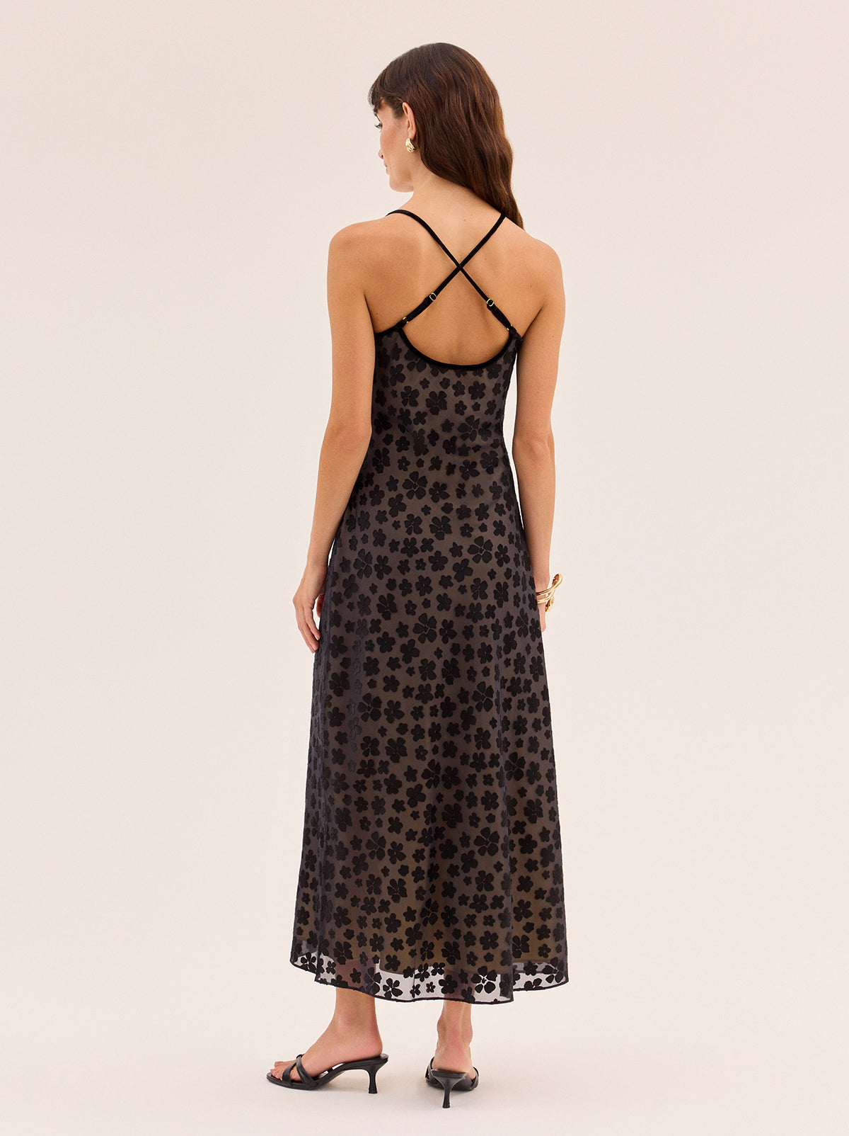 Karla Black Floral Dress by Kitri Studio. Karla Black Floral Dress is cut on the bias from our in-house designed black floral satin burnout, creating a fluid drape that skims the body with ease.  The yellow-gold satin lining adds subtle depth, while black velvet trim and delicate bows frame the neckline for a feminine finish. Scoop neck. Adjustable straps. Fully lined. 75% Viscose, 25% Nylon.