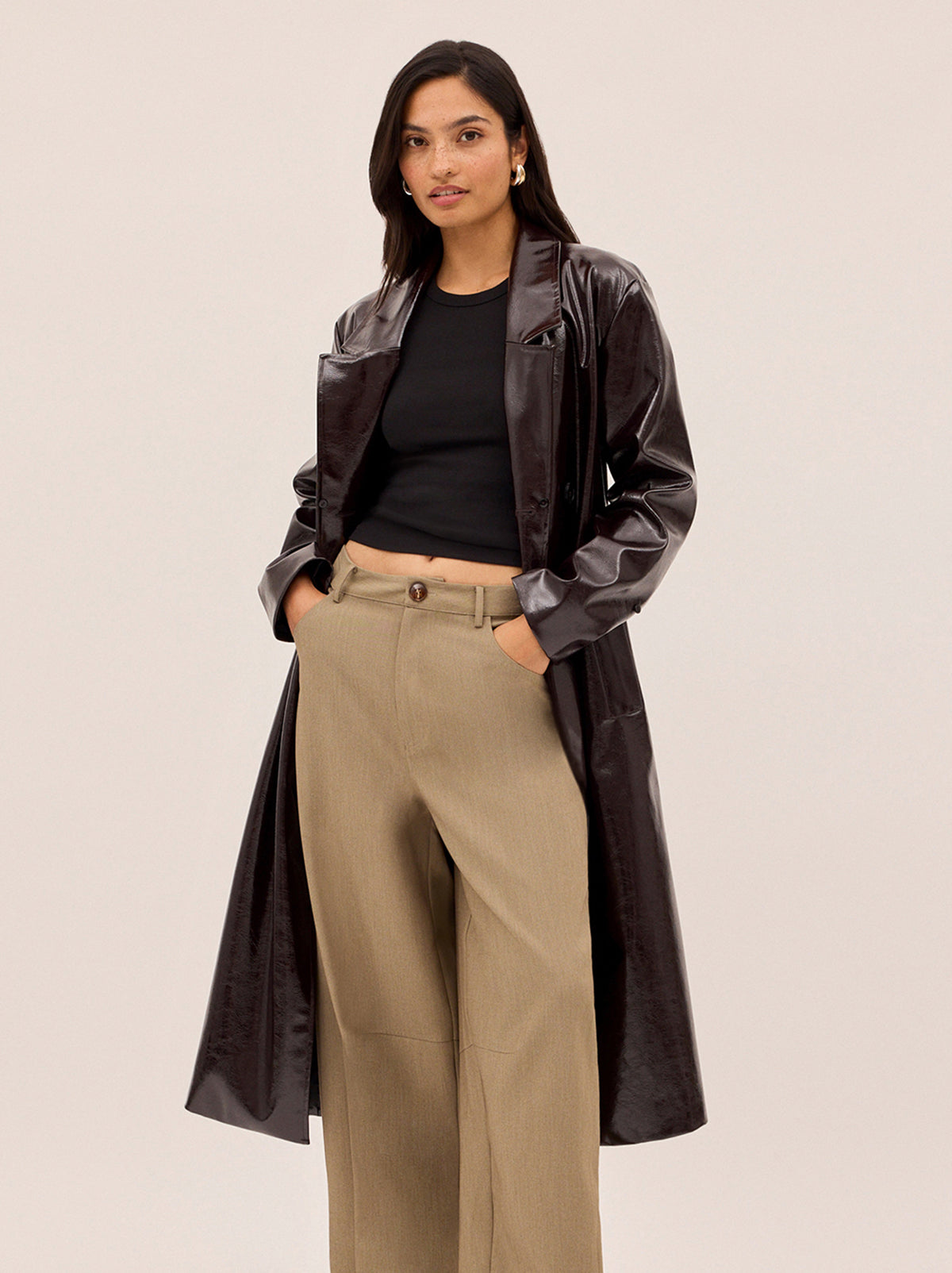 Lara Dark Chocolate Vinyl Coat by Kitri Studio. All eyes on Lara - dare we say, THE coat of the season and the ultimate statement-maker.  Cut from premium, chocolate brown vinyl, this double-breasted showstopper is finished with a detachable plush faux-fur collar and cuffs in deep chocolate for maximum drama. Collared neckline. Long sleeves. Button front. Main: 100% PU, Faux-Fur: 100% Polyester.