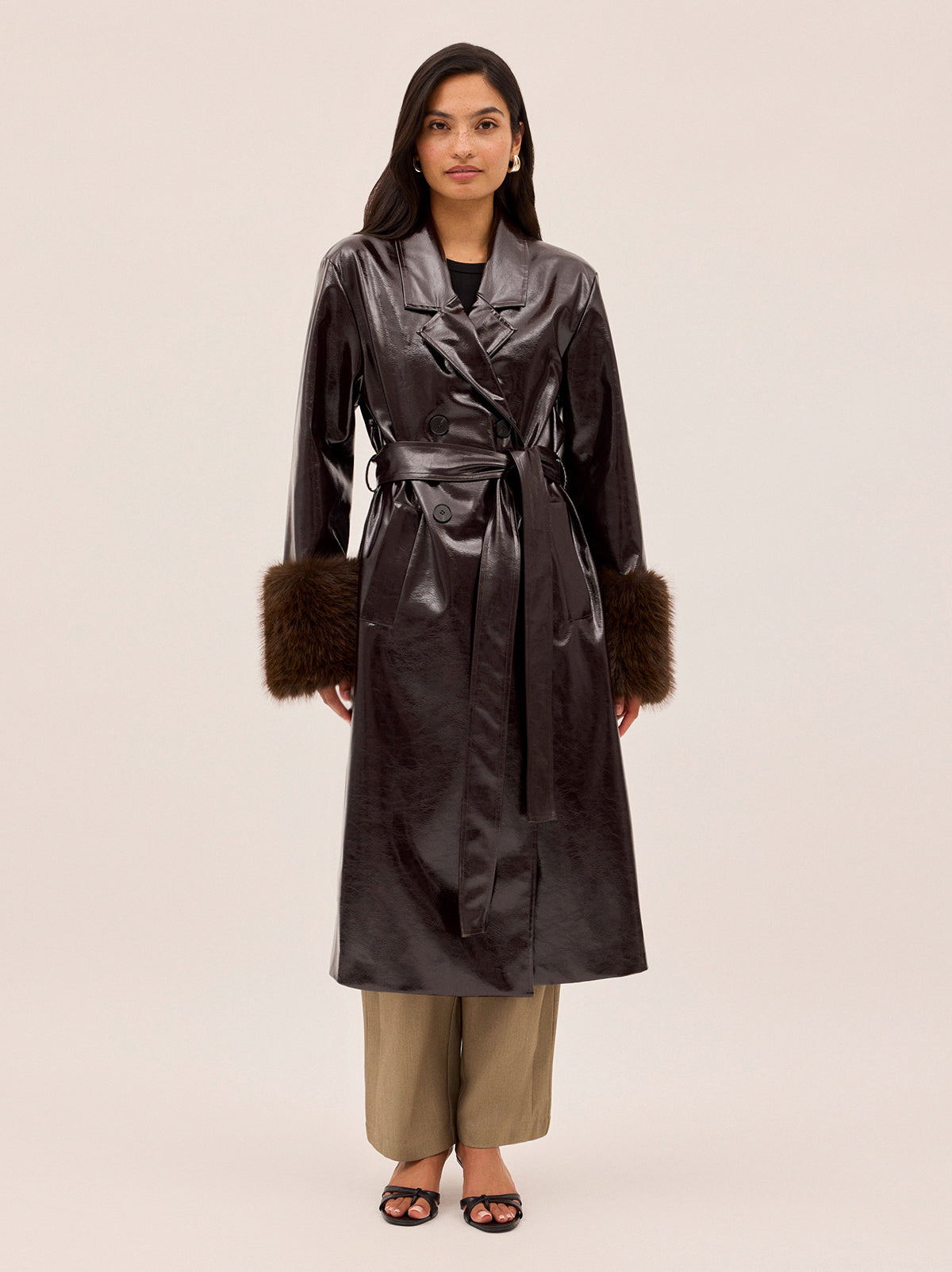 Lara Dark Chocolate Vinyl Coat by Kitri Studio. All eyes on Lara - dare we say, THE coat of the season and the ultimate statement-maker.  Cut from premium, chocolate brown vinyl, this double-breasted showstopper is finished with a detachable plush faux-fur collar and cuffs in deep chocolate for maximum drama. Collared neckline. Long sleeves. Button front. Main: 100% PU, Faux-Fur: 100% Polyester.