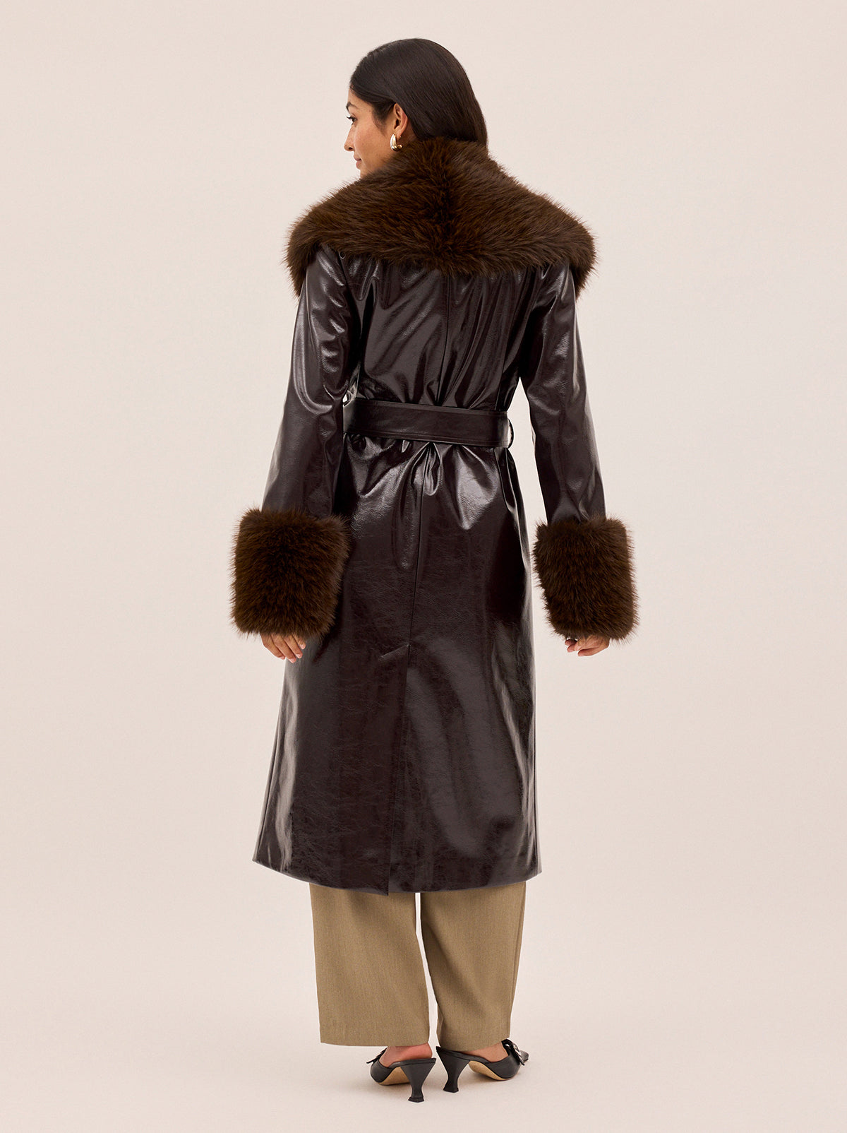 Lara Dark Chocolate Vinyl Coat by Kitri Studio. All eyes on Lara - dare we say, THE coat of the season and the ultimate statement-maker.  Cut from premium, chocolate brown vinyl, this double-breasted showstopper is finished with a detachable plush faux-fur collar and cuffs in deep chocolate for maximum drama. Collared neckline. Long sleeves. Button front. Main: 100% PU, Faux-Fur: 100% Polyester.
