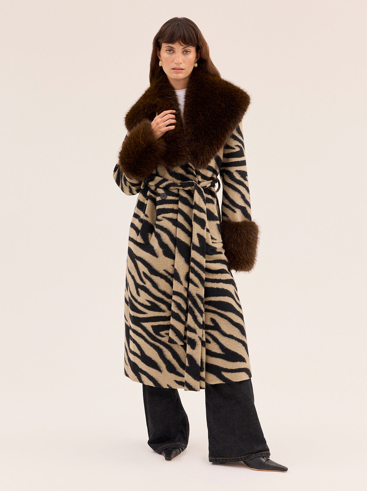 Lara Zebra Wool-Blend Coat by Kitri Studio. All eyes on Lara - THE coat of the season and the ultimate statement-maker.  Cut from wool-blend fabrication, this double-breasted showstopper is finished with a detachable plush faux-fur collar and cuffs in deep chocolate for maximum drama. Large collar. Long sleeves. Button front. Main: 30% Wool, 70% Polyester Faux Fur: 100% Polyester.