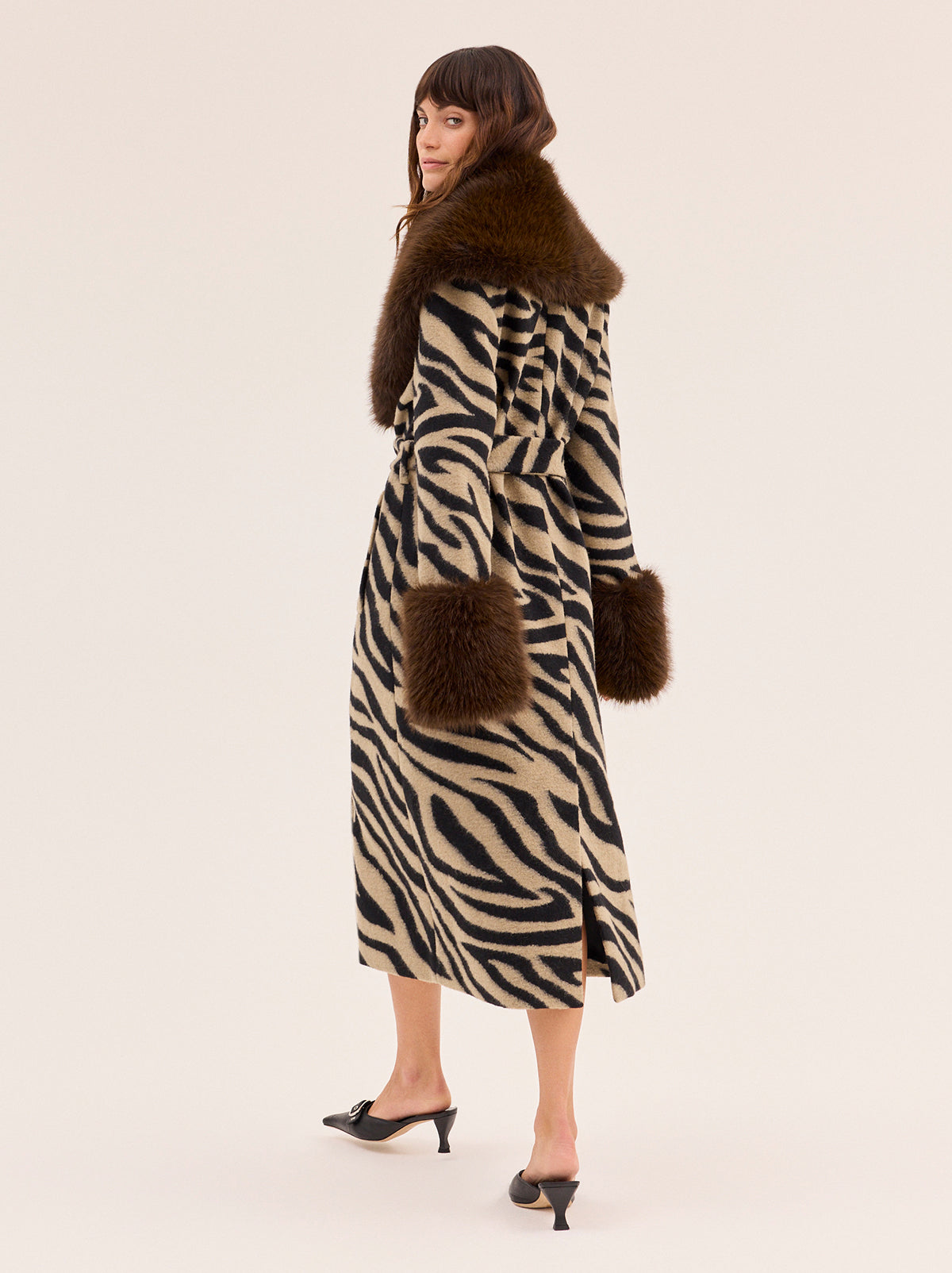 Lara Zebra Wool-Blend Coat by Kitri Studio. All eyes on Lara - THE coat of the season and the ultimate statement-maker.  Cut from wool-blend fabrication, this double-breasted showstopper is finished with a detachable plush faux-fur collar and cuffs in deep chocolate for maximum drama. Large collar. Long sleeves. Button front. Main: 30% Wool, 70% Polyester Faux Fur: 100% Polyester.