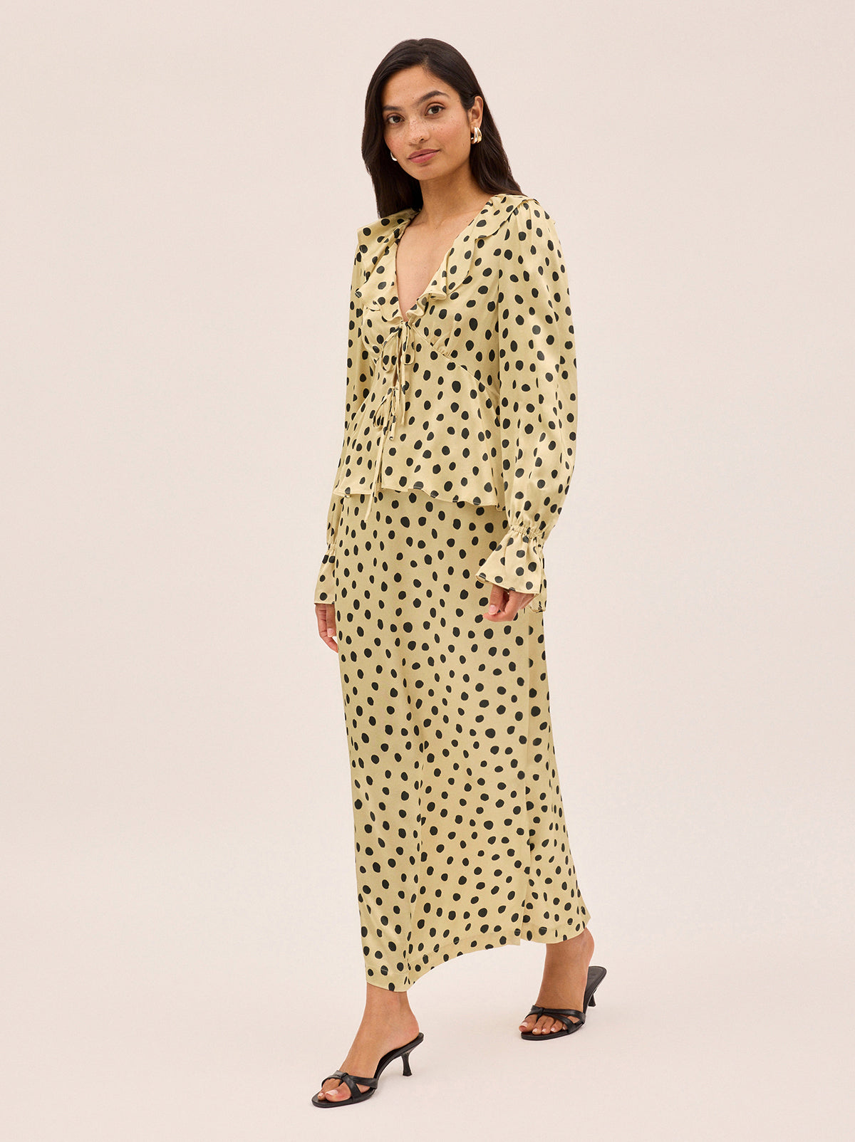 Laurel Butter Polka Dot Satin Skirt by Kitri Studio. Bring a little retro romance into your everyday with our Laurel Butter Polka Dot Satin Skirt.  Crafted from smooth, fluid viscose satin, this mid-waist maxi is printed with our signature butter-based polka dots - a timeless neutral with endless styling potential. Concealed side-zip. High waisted. Bias cut. 100% Viscose Satin.