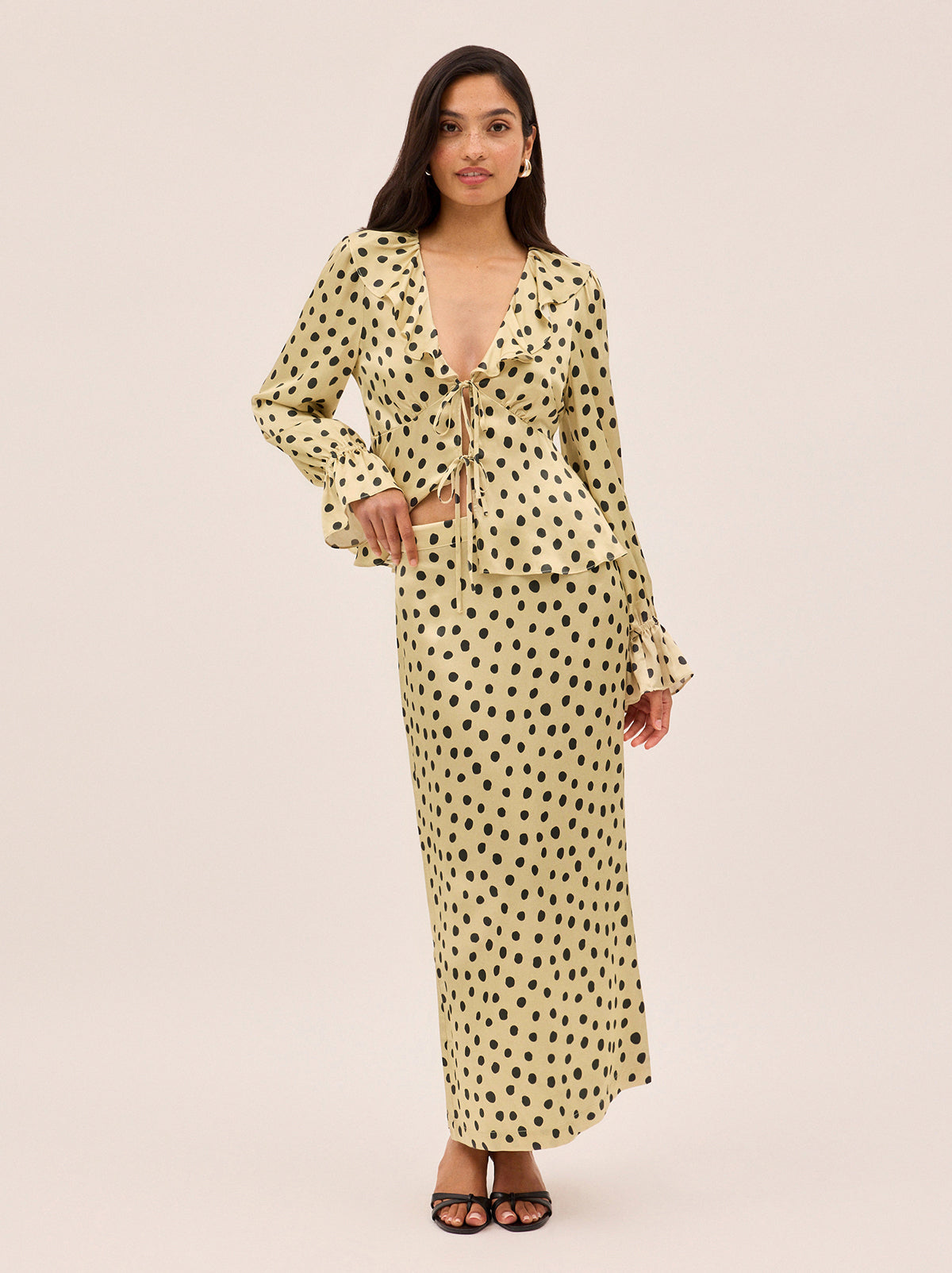 Laurel Butter Polka Dot Satin Skirt by Kitri Studio. Bring a little retro romance into your everyday with our Laurel Butter Polka Dot Satin Skirt.  Crafted from smooth, fluid viscose satin, this mid-waist maxi is printed with our signature butter-based polka dots - a timeless neutral with endless styling potential. Concealed side-zip. High waisted. Bias cut. 100% Viscose Satin.