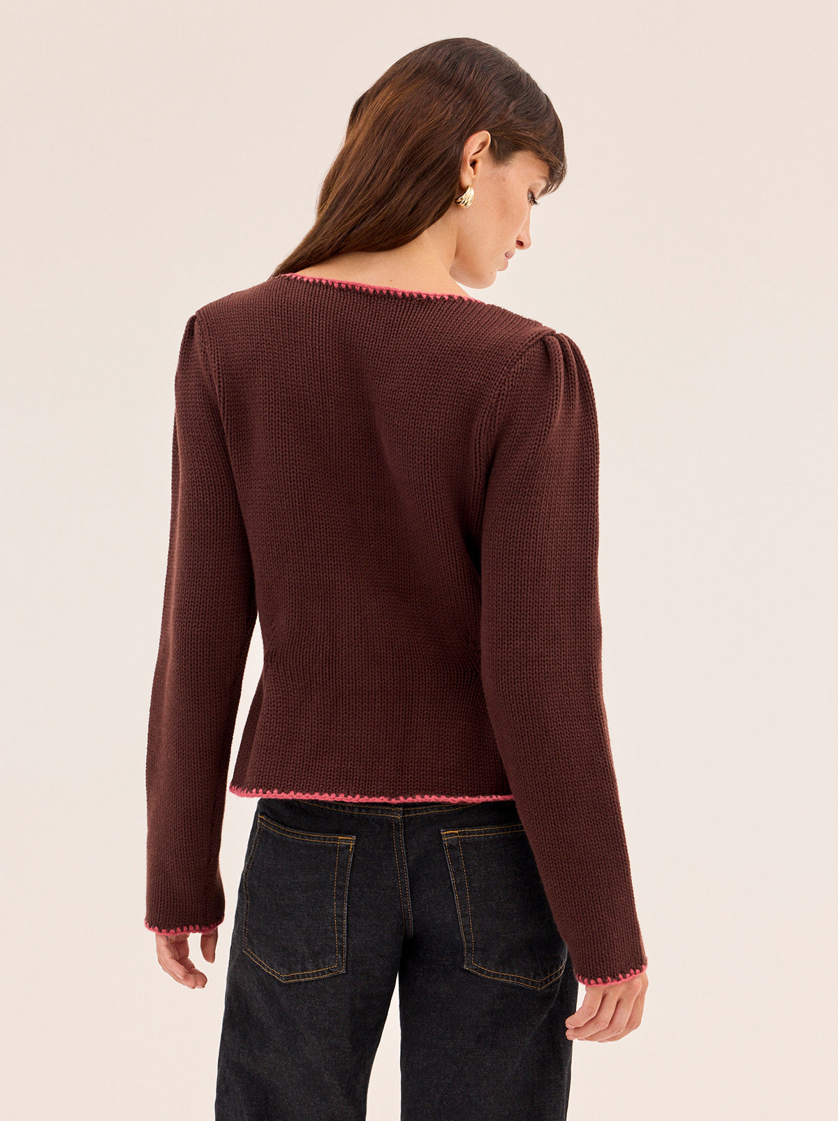 Leonie Chocolate Embroidered Knit Cardigan by Kitri Studio. A true heirloom-in-the-making, this vintage-inspired knit cardigan blends craftsmanship with everyday wearability.  Spun from a mid-weight cotton-wool blend, it’s detailed with intricate, hand-embroidered florals in rich autumnal tones. Slash Neck. Long sleeves. Button front. 60% Cotton, 30% Nylon, 10% Wool.