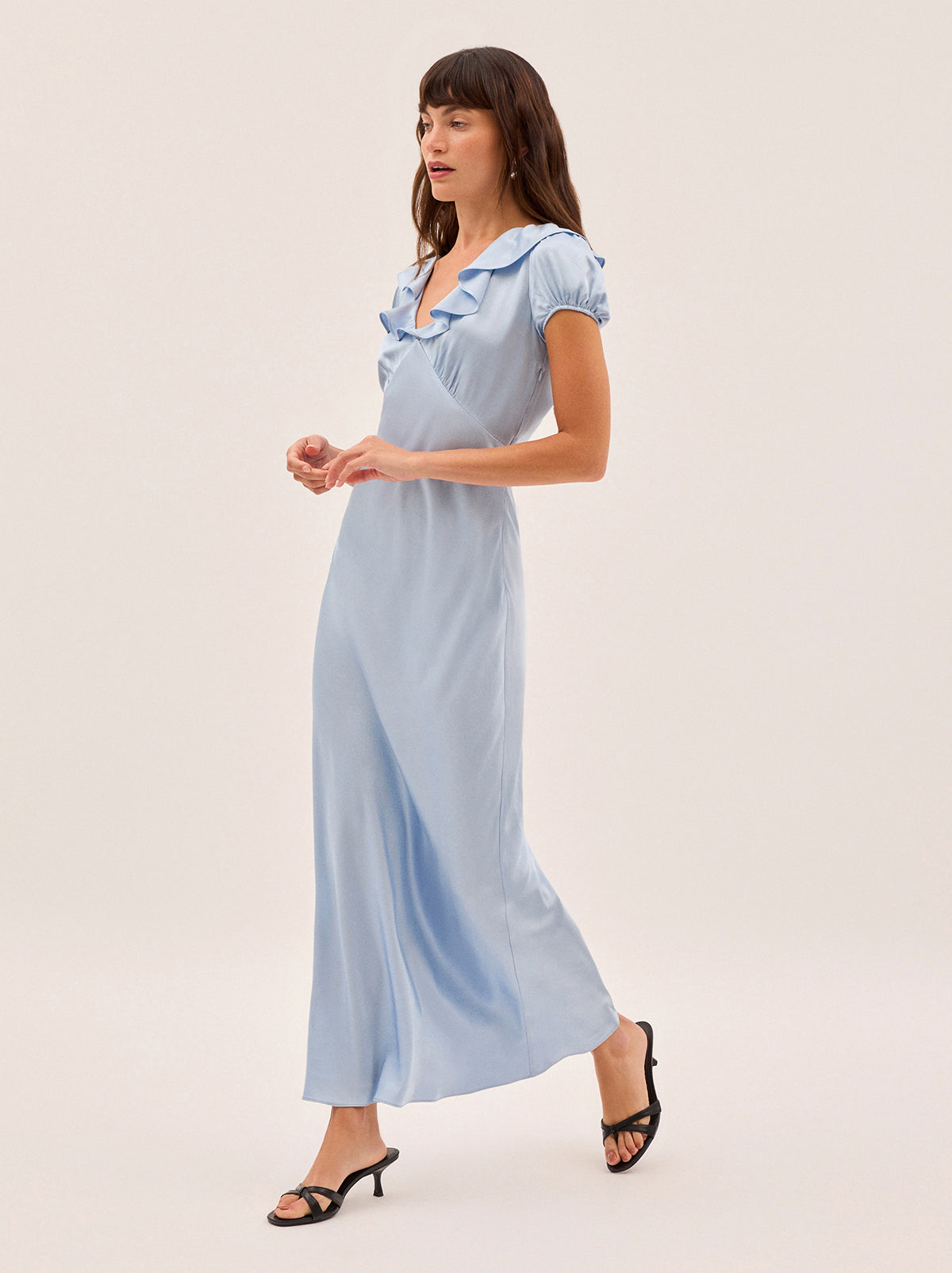 Minka Powder Blue Satin Dress by Kitri Studio. Introducing the Minka dress - a new romantic silhouette in a dreamy powder blue hue.  Crafted from fluid viscose satin and bias-cut for an elegant drape, it features a flattering empire line, deep V-neckline with soft frill detail, and short puff sleeves. V-neck. Puff sleeves. Elasticated cuffs. 100% Viscose Satin.