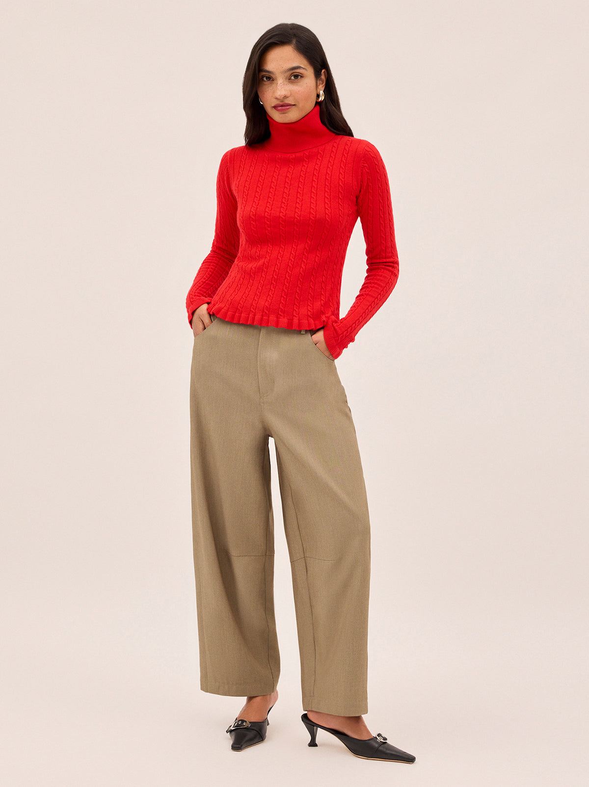 Nella Red Wool-Blend Roll Neck Jumper by Kitri Studio. This lightweight wool-blend roll-neck jumper in a striking red is the ultimate layering hero for the cooler months.  Designed with a subtle cable knit, cosy roll neck, and delicate frill detailing at the cuffs and hem, it strikes the perfect balance between feminine charm and everyday ease. High neckline. Long sleeves. Slim fit. 5% Cashmere, 20% Wool, 27% Viscose, 48% Nylon.