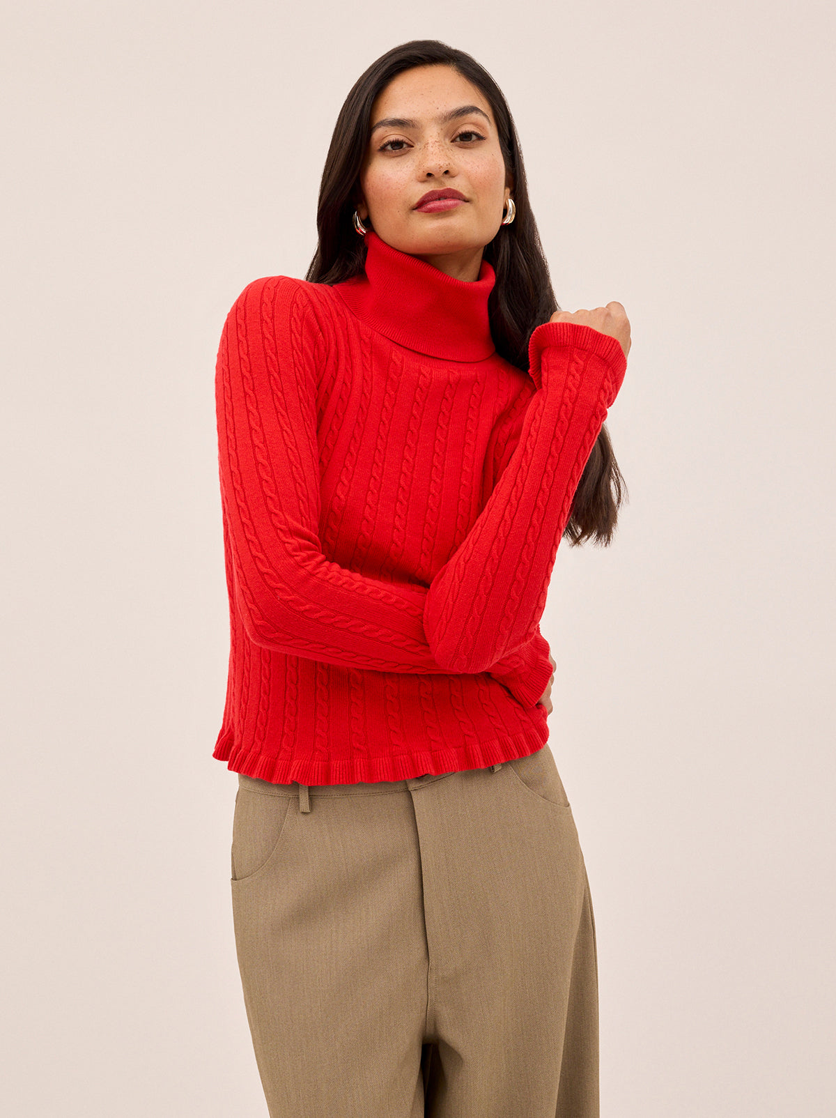 Nella Red Wool-Blend Roll Neck Jumper by Kitri Studio. This lightweight wool-blend roll-neck jumper in a striking red is the ultimate layering hero for the cooler months.  Designed with a subtle cable knit, cosy roll neck, and delicate frill detailing at the cuffs and hem, it strikes the perfect balance between feminine charm and everyday ease. High neckline. Long sleeves. Slim fit. 5% Cashmere, 20% Wool, 27% Viscose, 48% Nylon.