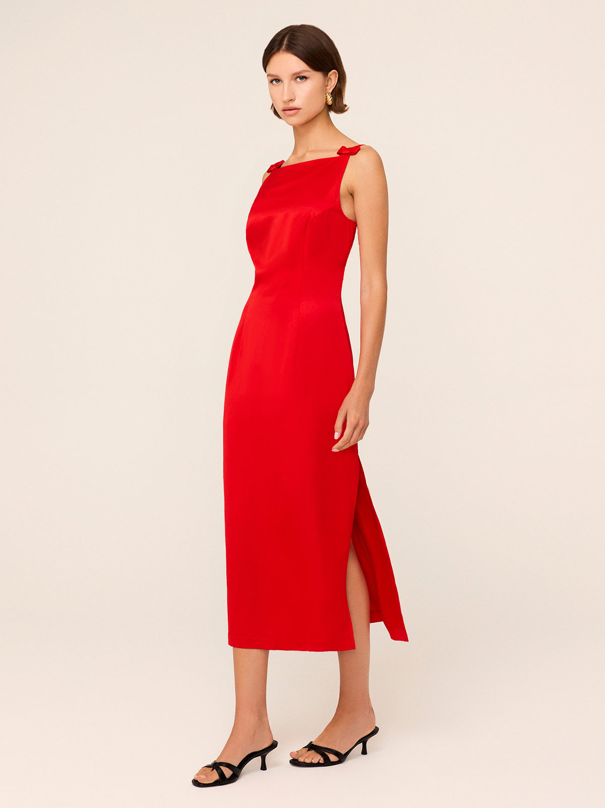 Nikita Red Satin Midi Dress - Nikita is an elegant, '90s-inspired midi dress with a split sheath skirt and low back. She's crafted from a premium salsa red viscose linen blend, providing a subtle sheen and unique rippling effect. Her bow details add a feminine touch and heralds the ballet-theme at the heart of our collection.