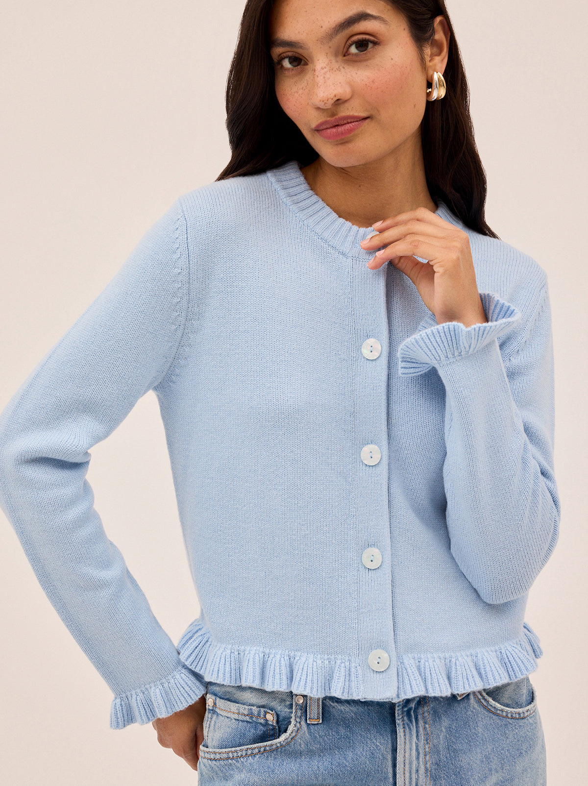 Odile Powder Blue Knit Cardigan by Kitri Studio. The Odile cardigan is a refined wardrobe staple with a playful twist.  Knitted from a soft, mid-weight cashmere blend, it features a classic button-down front, with delicate frill detailing at the hem and cuffs. Round neck. Long sleeves. Frilled cuffs. 5% Cashmere, 20% Wool, 27% Viscose, 48% Nylon.