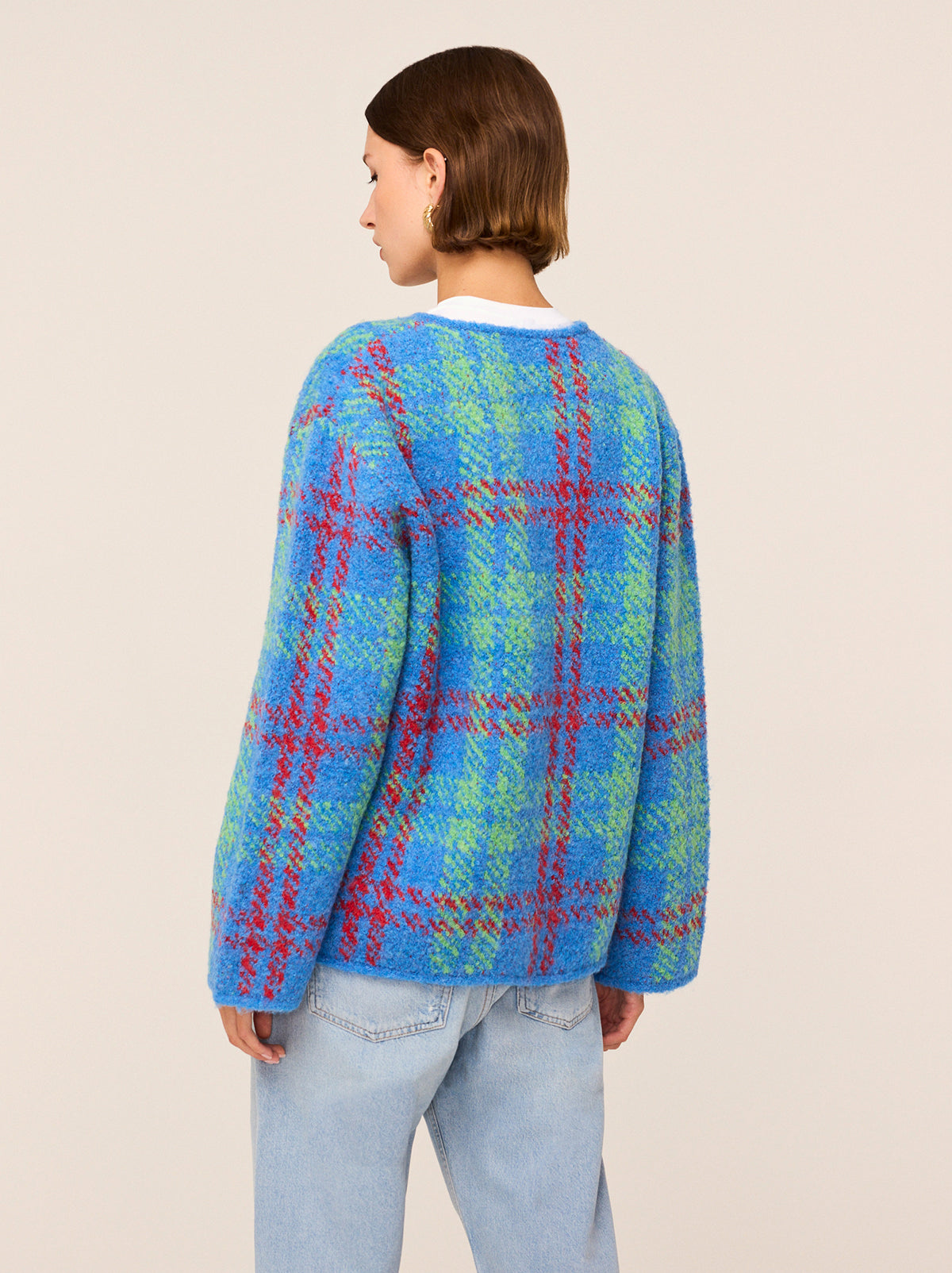 Pandora Blue Check Bouclé Knit Cardigan - Pandora is a chunky, wool-blend cardigan featuring a bold check print inspired by the punk-chic runways of the '90s. A fresh cobalt blue base is crisscrossed with shocks of red and green, and her cosy bouclé fabric makes her the perfect extra layer as the weather cools. 