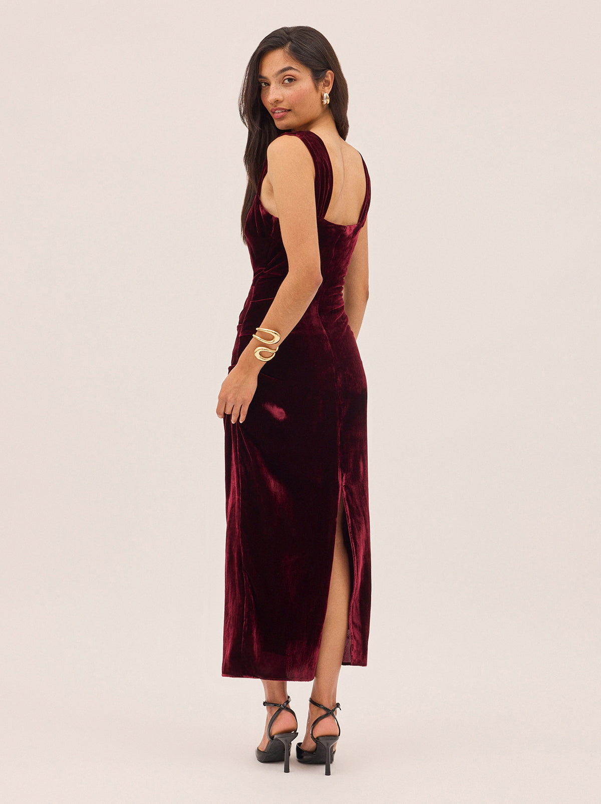 Rita Burgundy Velvet Dress by Kitri Studio. Retro-inspired and effortlessly flattering.  The Rita Burgundy Velvet Dress is crafted from a soft viscose velvet in rich burgundy hue, with wide gathered straps and gentle ruching through the bodice for a sculpted, feminine fit. Straight neckline. sleeveless. Back-zip. 80% Viscose, 20% Nylon.