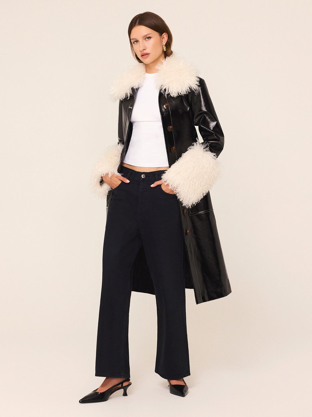 Simone Black Vinyl Coat - Simone is a black vintage-inspired vinyl coat with a removable faux-fur collar and cuffs for extra versatility. A relaxed fit with large patch pockets at the front, it comes with a buckled belt to cinch in at the waist. 