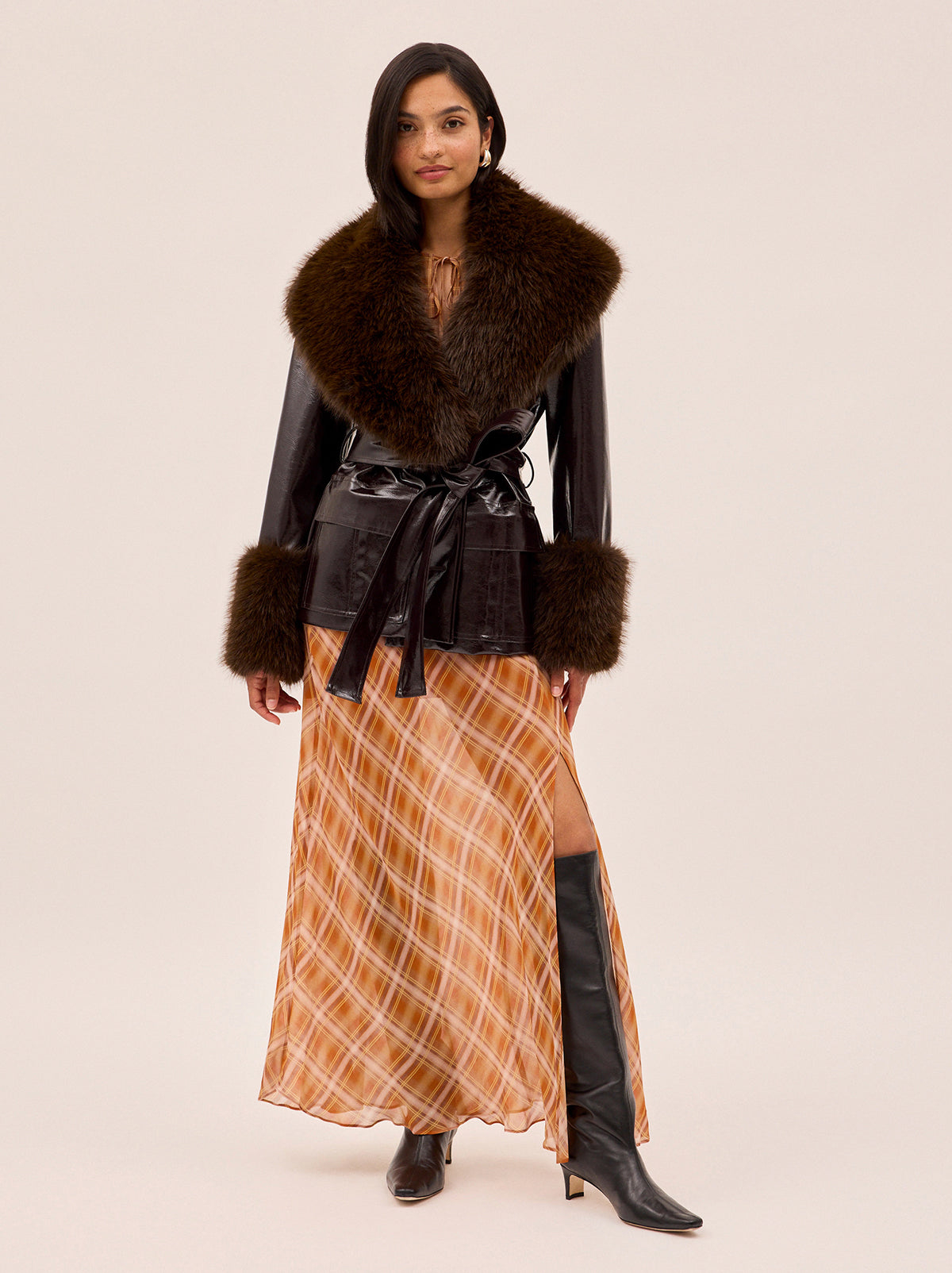 Zoe Apricot Check Print Skirt by Kitri Studio. The Zoe skirt is a flowing, feminine maxi crafted from semi-sheer viscose georgette in our exclusive apricot check print.  Designed with a mid-rise fit, it features a leg-baring split and is half lined for just the right amount of coverage. Half-lined. Elasticed waist. Flared skirt. 100% Viscose Georgette.