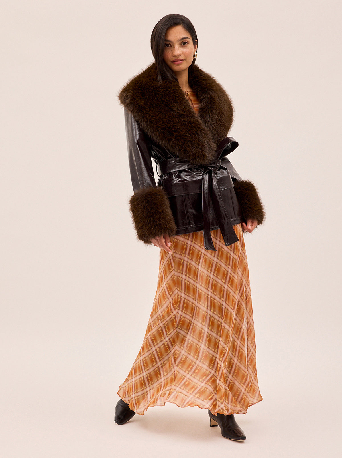 Zoe Apricot Check Print Skirt by Kitri Studio. The Zoe skirt is a flowing, feminine maxi crafted from semi-sheer viscose georgette in our exclusive apricot check print.  Designed with a mid-rise fit, it features a leg-baring split and is half lined for just the right amount of coverage. Half-lined. Elasticed waist. Flared skirt. 100% Viscose Georgette.