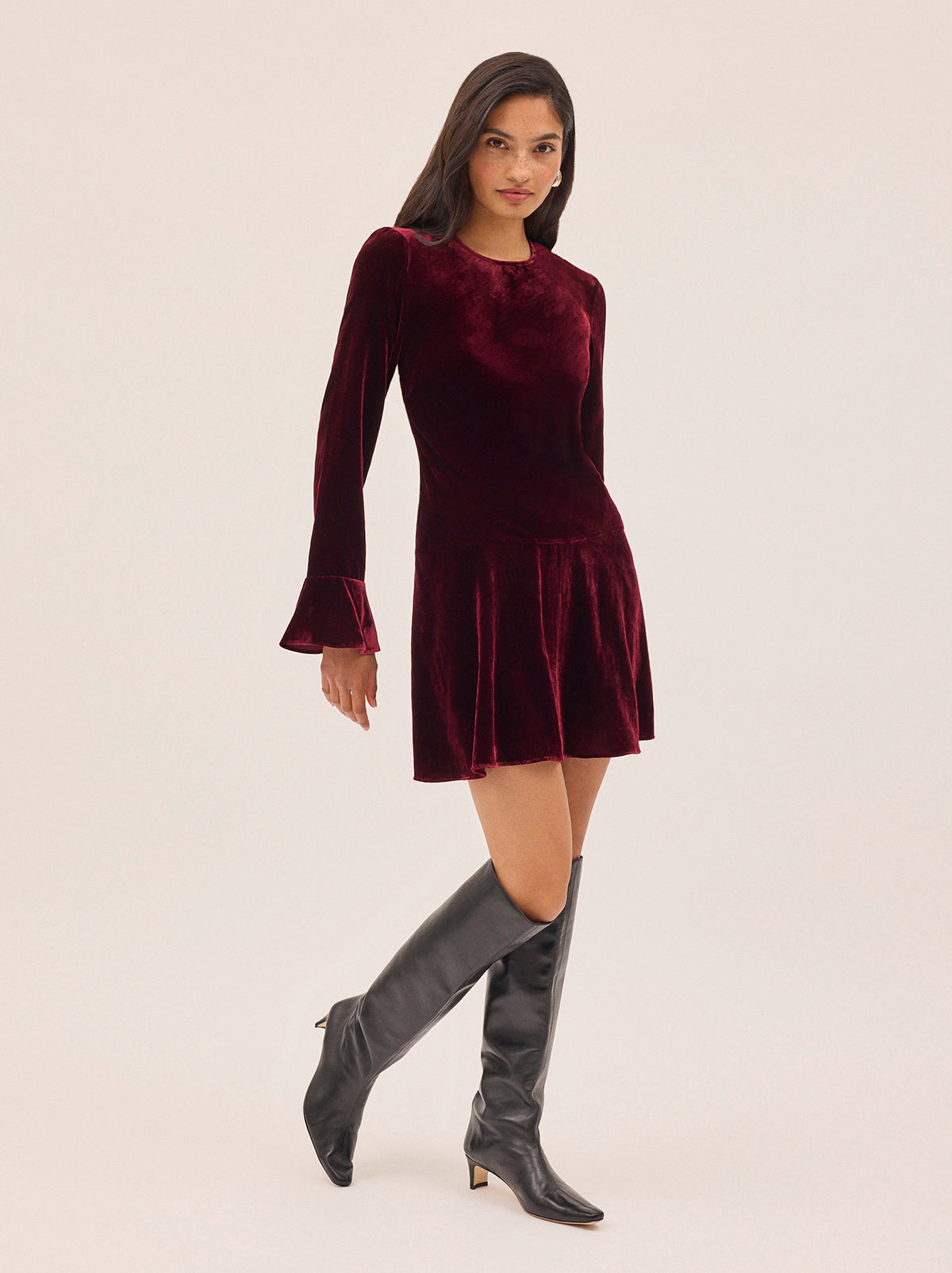 Stefania Burgundy Velvet Mini Dress by Kitri Studio. Flirty, fun, and effortlessly chic—the Stefania Mini Dress is your new go-to for day-to-night dressing.  Crafted in deep burgundy velvet, this long-sleeve mini dress features fluted cuffs and a softly flared hem for the perfect touch of movement. Round neck. Flared sleeves. A-line skirt. 80% Viscose, 20% Nylon.