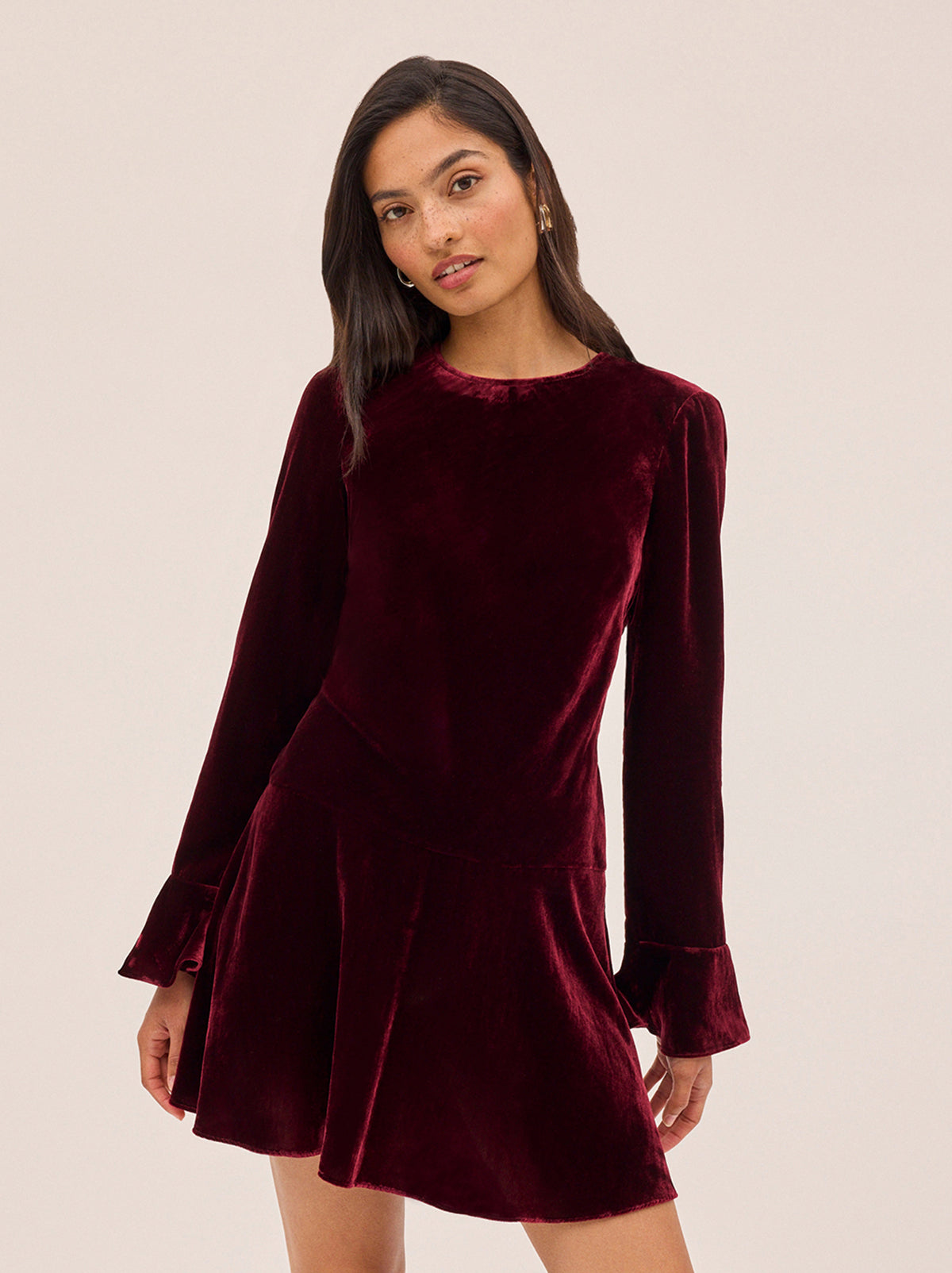 Stefania Burgundy Velvet Mini Dress by Kitri Studio. Flirty, fun, and effortlessly chic—the Stefania Mini Dress is your new go-to for day-to-night dressing.  Crafted in deep burgundy velvet, this long-sleeve mini dress features fluted cuffs and a softly flared hem for the perfect touch of movement. Round neck. Flared sleeves. A-line skirt. 80% Viscose, 20% Nylon.