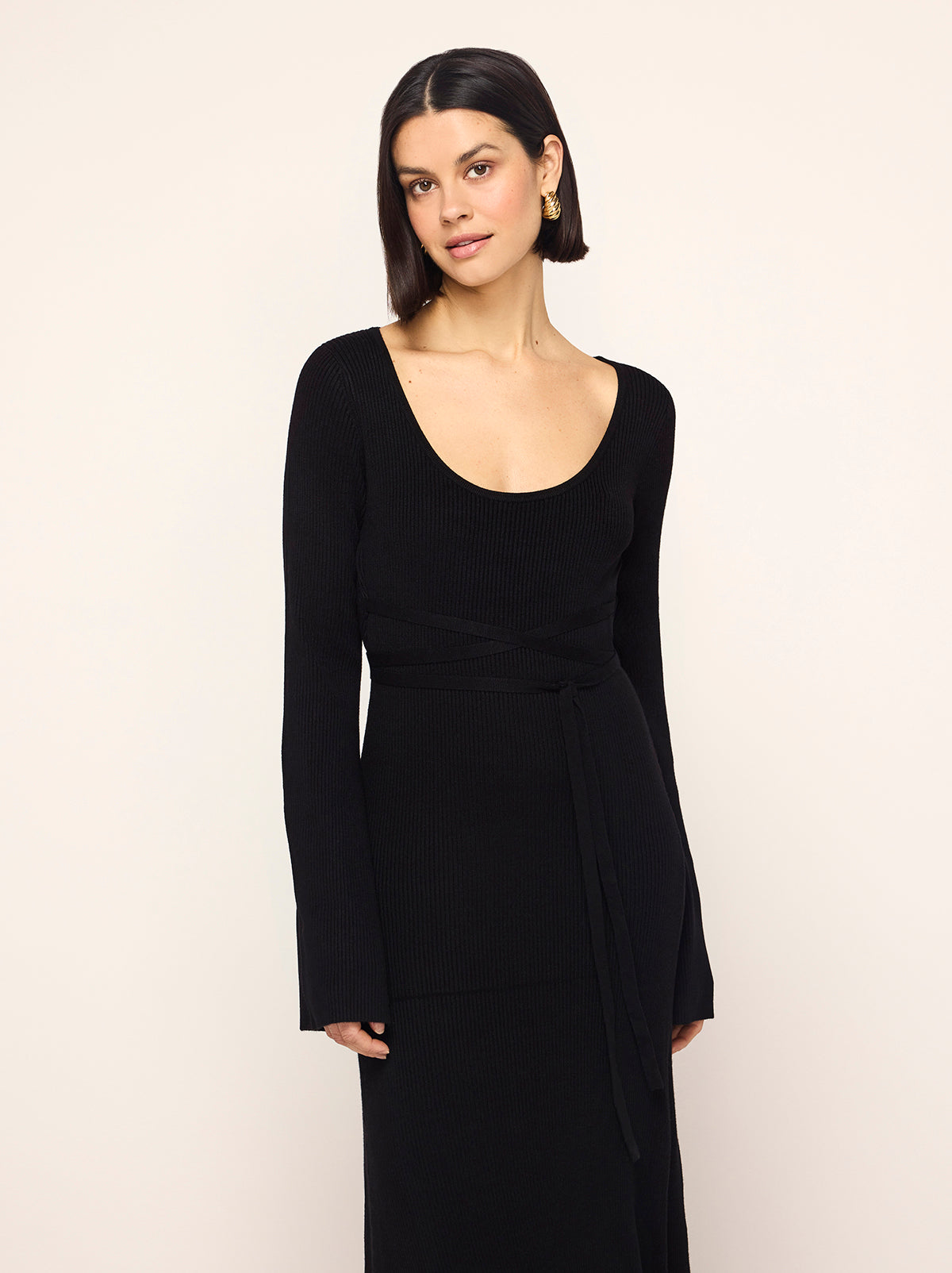 Darryl Black Ribbed Knit Dress - Darryl is a black ribbed knit midi dress with a flattering scoop neckline and feminine flare sleeves. Her ballet-inspired wrap-around tie waist detail flatters the silhouette. She'll look great with your favourite knee high boots.