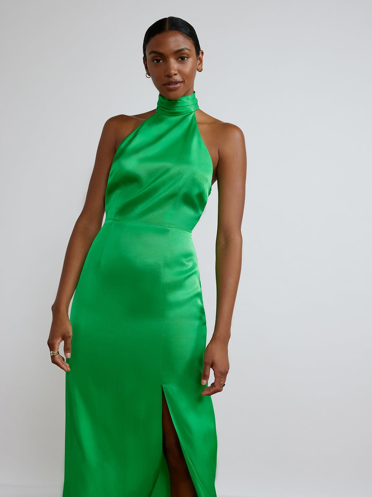 The Gwen Halterneck Dress By KITRI Studio in solid emerald green makes a perfect bridesmaid dress. Statement midi dress with sleeveless and backless halterneck design and waist length scarf/ribbon at the back.