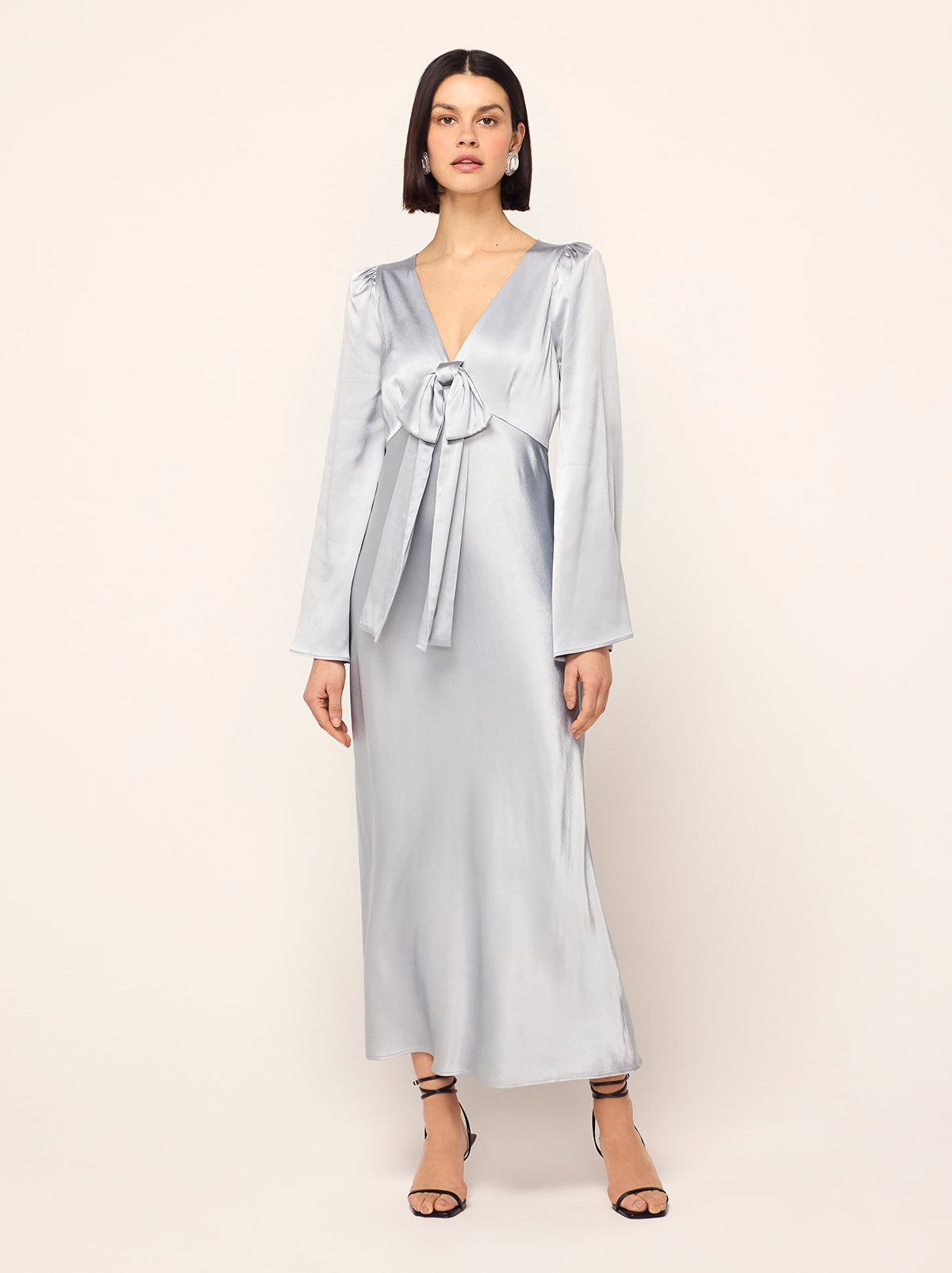 Lily Silver Satin Bow Dress - Lily is a flattering midi dress with an elegant silhouette and fluted sleeves. Her icy silver fabrication catches the light and creates a beautiful drape. Her darted bustline keeps things comfortable and her bow detail adds touch of theatre. 