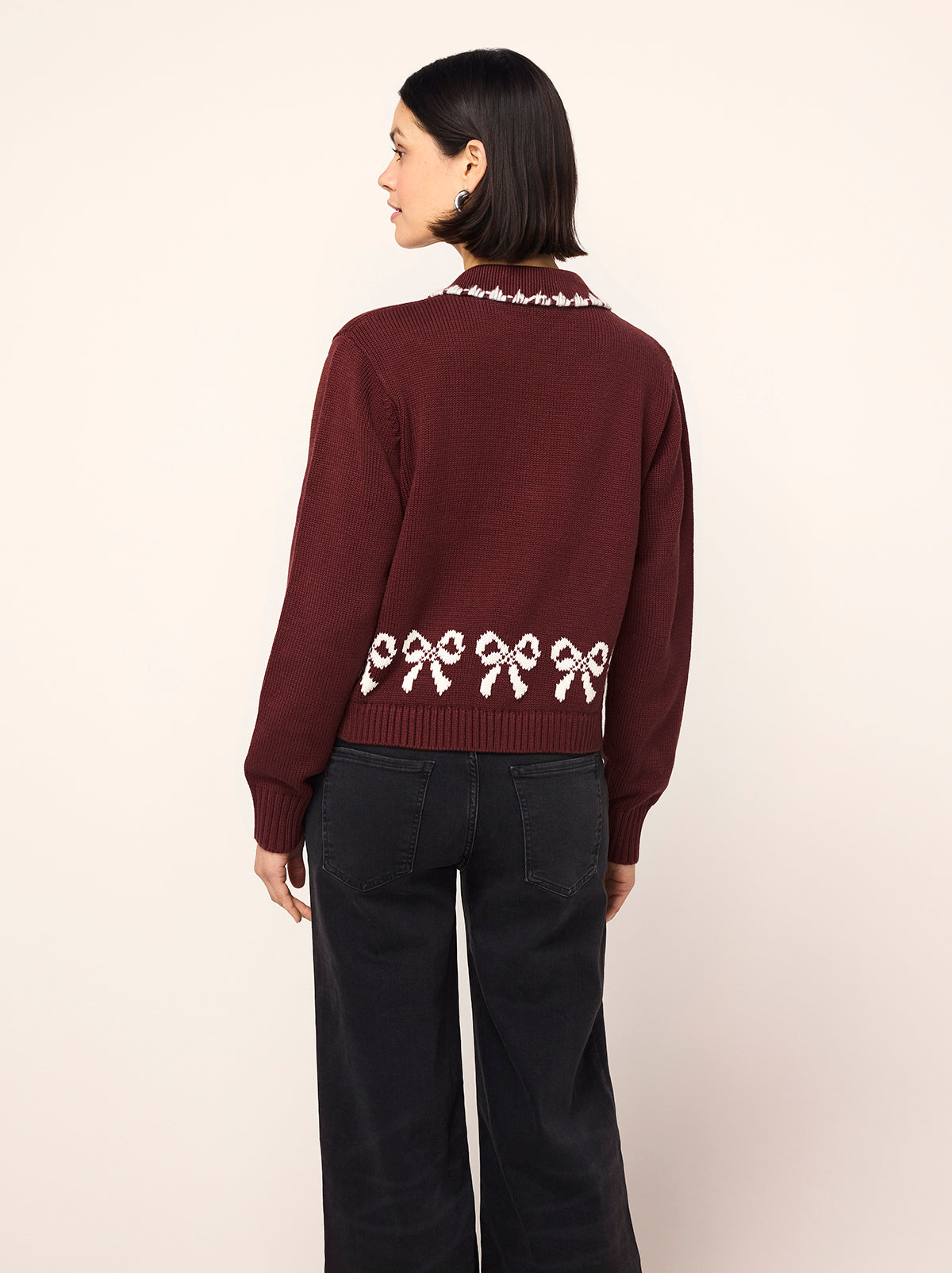 Polly Oxblood Bow Knit Cardigan - Polly is an oxblood cardigan with a contrasting ivory bow intarsia and crafted from a cosy cotton blend. Her ribbed sleeves and self-covered buttons make her a cut above the rest.