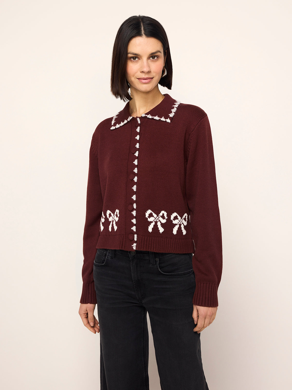 Polly Oxblood Bow Knit Cardigan - Polly is an oxblood cardigan with a contrasting ivory bow intarsia and crafted from a cosy cotton blend. Her ribbed sleeves and self-covered buttons make her a cut above the rest.