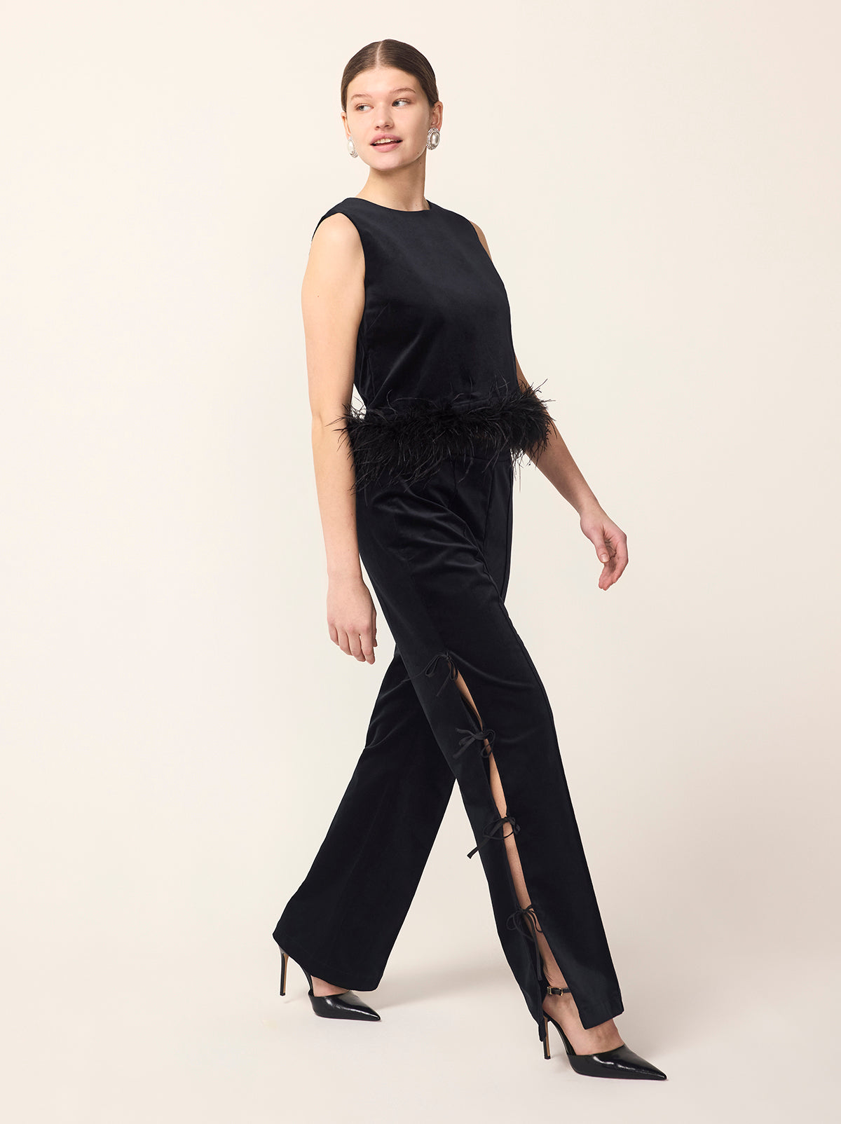 Rosamund Black Velvet Trousers - Rosamund is a straight-leg pin-tuck trouser with functional satin ties along to outer edge of each leg. Crafted from our new cotton-blend velvet, she is structured whilst still feeling soft to the touch. Pair with co-ordinating Marlene Black Velvet Feather Blazer and Lou Lou Black Velvet Feather Top.