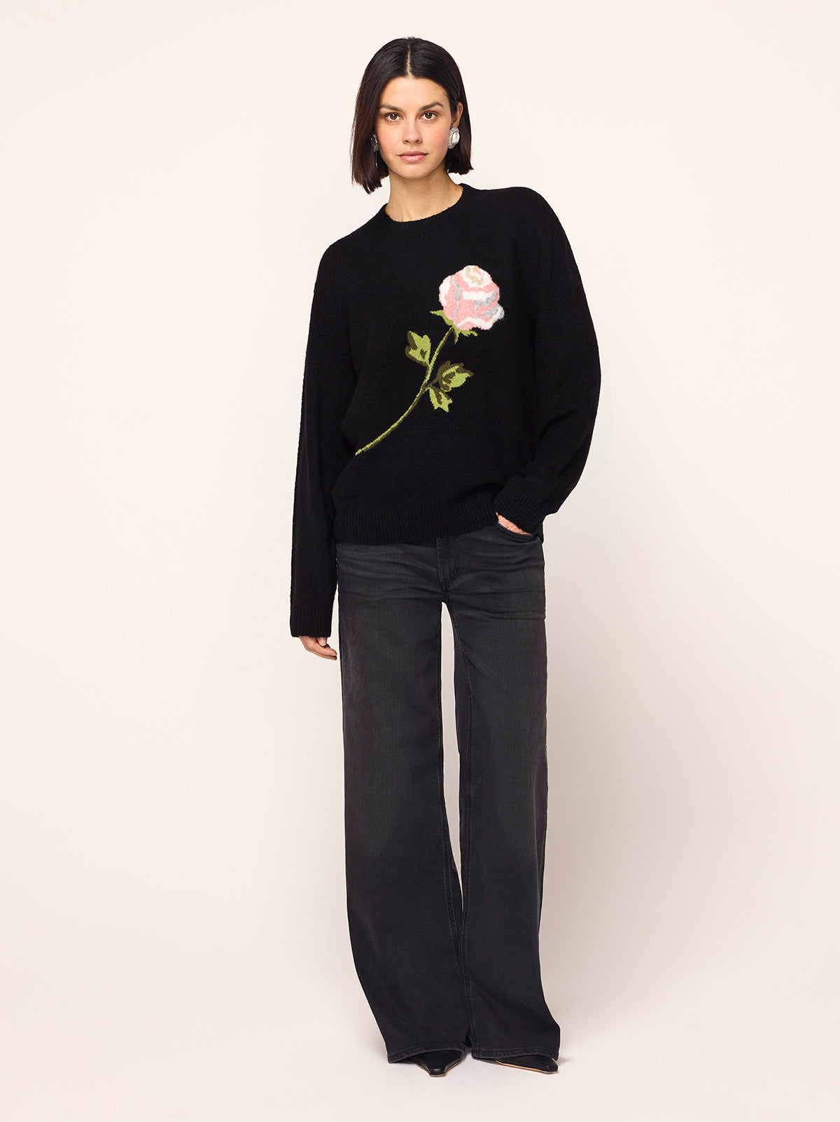 Rowan Black Rose Oversized Sweater - Rowan is a chic black jumper with long sleeves, a round neck and an in-house designed frosty rose motif inspired by the magic of a standing ovation, with roses raining from theatre balconies. 