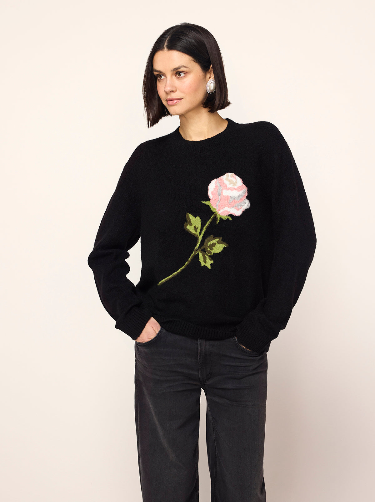 Rowan Black Rose Oversized Sweater - Rowan is a chic black jumper with long sleeves, a round neck and an in-house designed frosty rose motif inspired by the magic of a standing ovation, with roses raining from theatre balconies. 