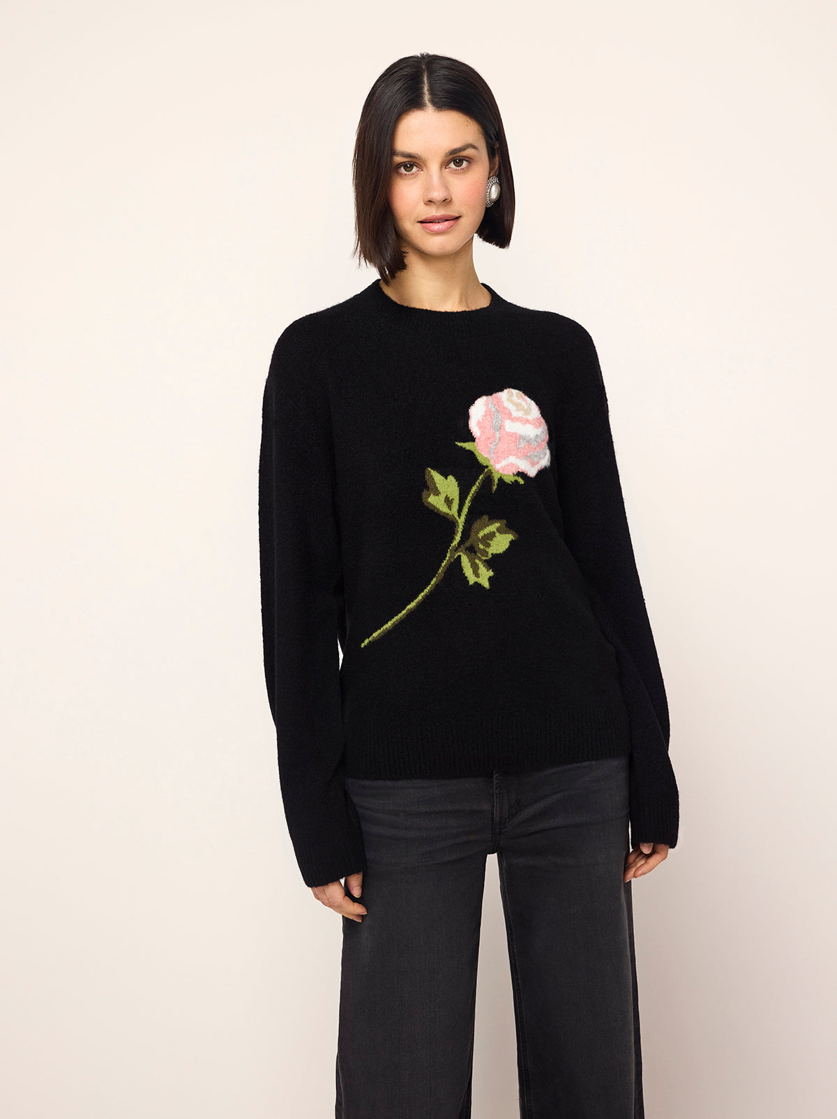 Rowan Black Rose Oversized Sweater - Rowan is a chic black jumper with long sleeves, a round neck and an in-house designed frosty rose motif inspired by the magic of a standing ovation, with roses raining from theatre balconies. 