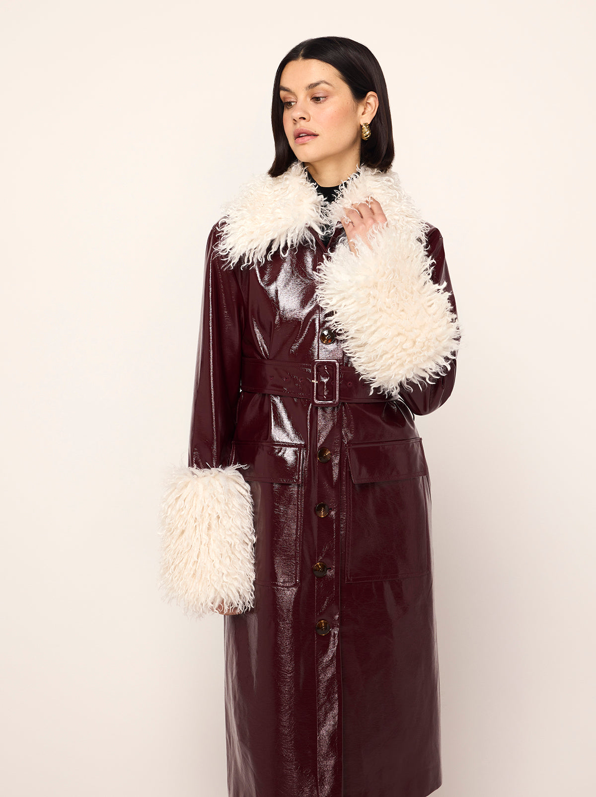 Simone Oxblood Vinyl Coat - Simone is a oxblood vintage-inspired vinyl coat with a removable faux-fur collar and cuffs for extra versatility. A relaxed fit with large patch pockets at the front, it comes with a buckled belt to cinch in at the waist.